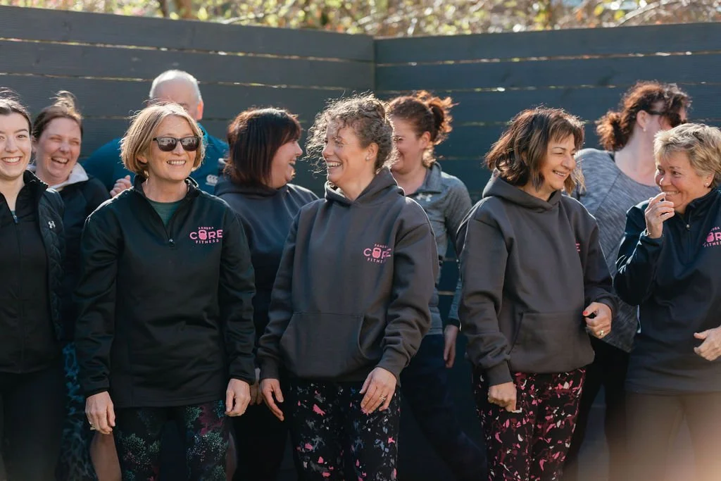 Group of women smiling after a fitness class
