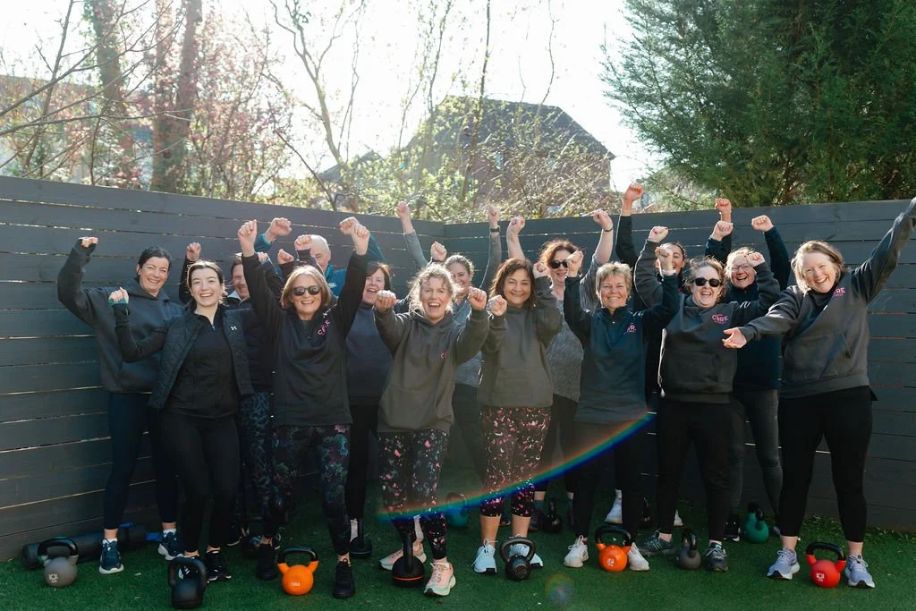 Holmes Core Fitness class members cheering together