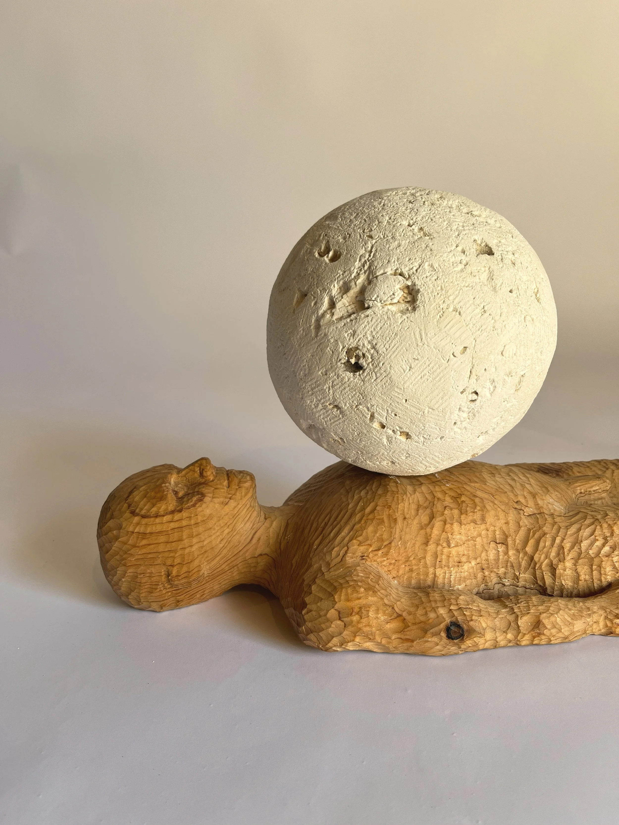 Weight of the world, 2025. Cedar and limestone - 25 x 52 x 15 cm 