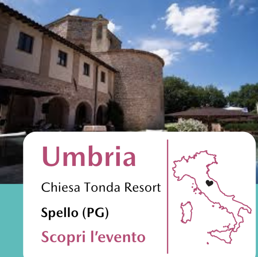 Un edificio storico in pietra con un campanile, situato in Umbria, Italia, sotto un cielo azzurro con alcune nuvole.