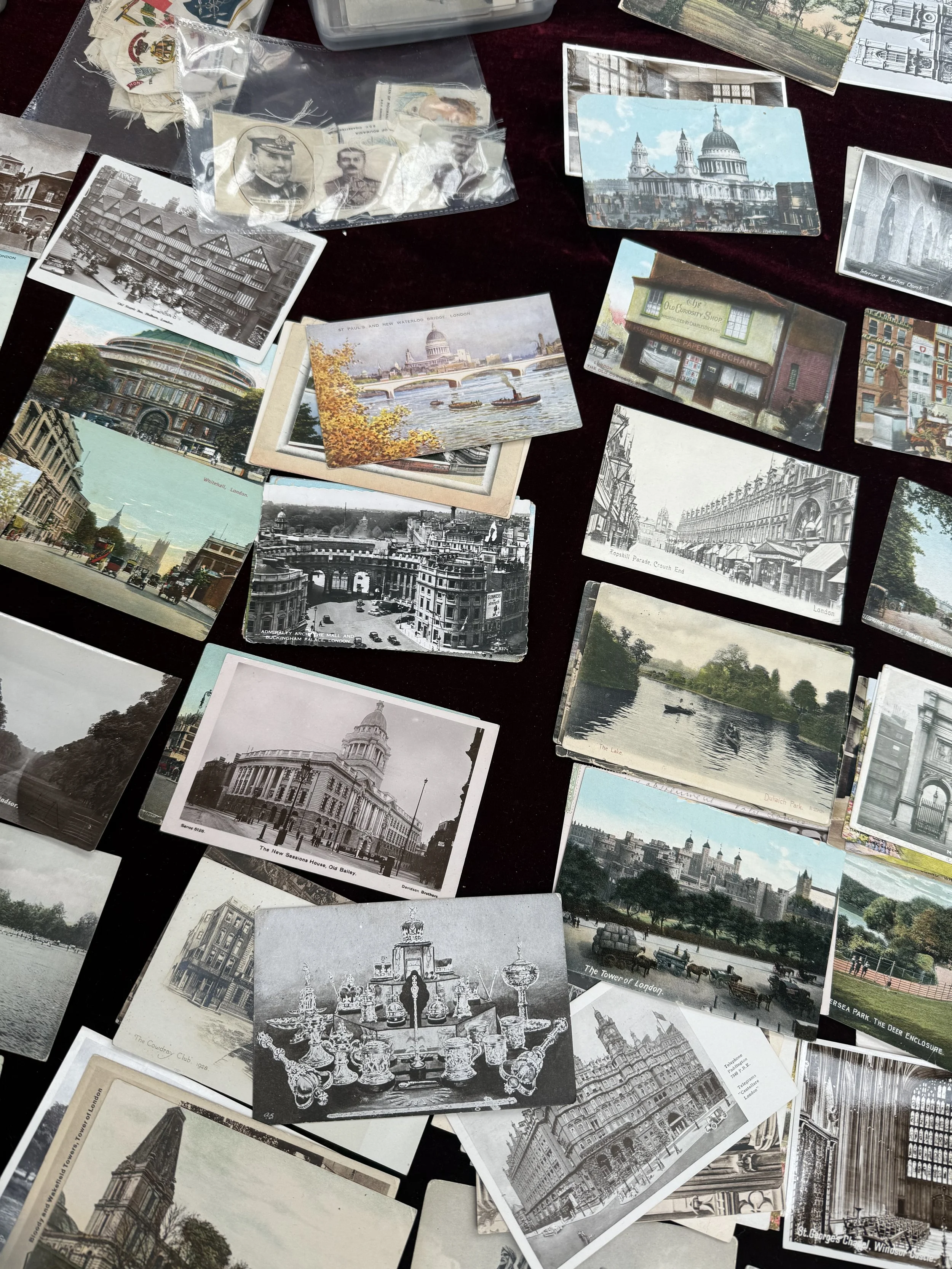 A collection of vintage postcards featuring various scenes and landmarks from London, including the Palace of Westminster, St. Paul's Cathedral, and other historical buildings and cityscapes.