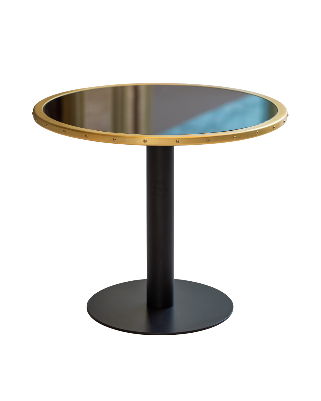 Round side table with a black pedestal base and a gold-colored rimmed mirror top reflecting an indoor scene.