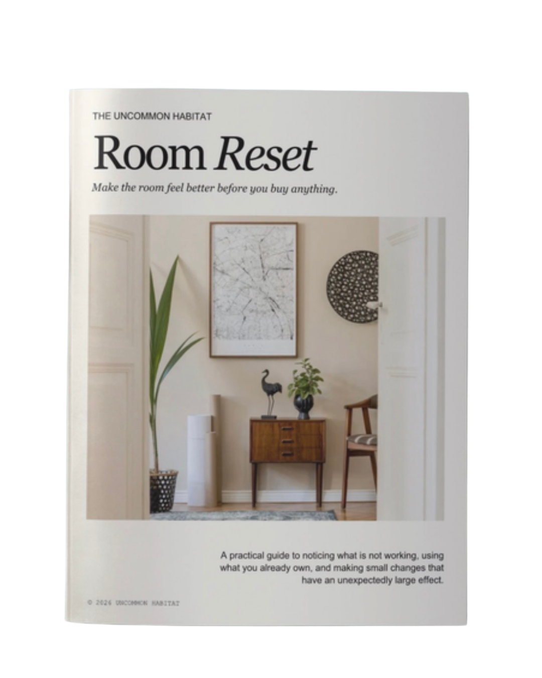 Book titled "Room Reset" featuring a minimalist interior of a small entryway with a wooden cabinet, decorative items, and wall art.