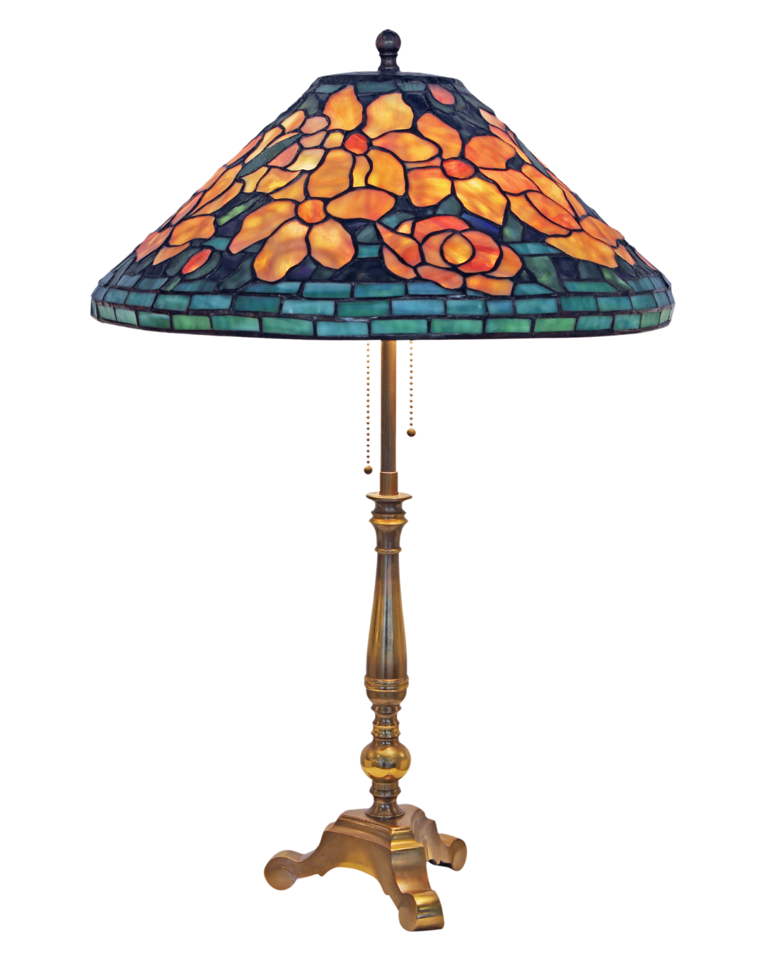 A Tiffany-style stained glass table lamp with a floral design on the shade and carved wooden base.