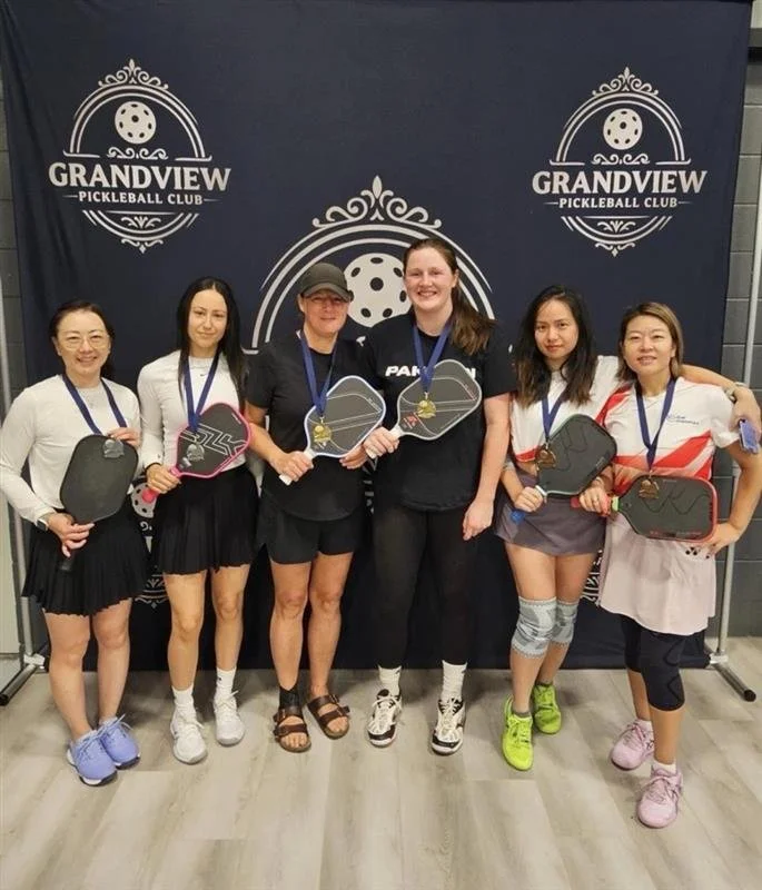 Janelle Albert with a gold medal at a pickleball tournament at grandview pickleball club.