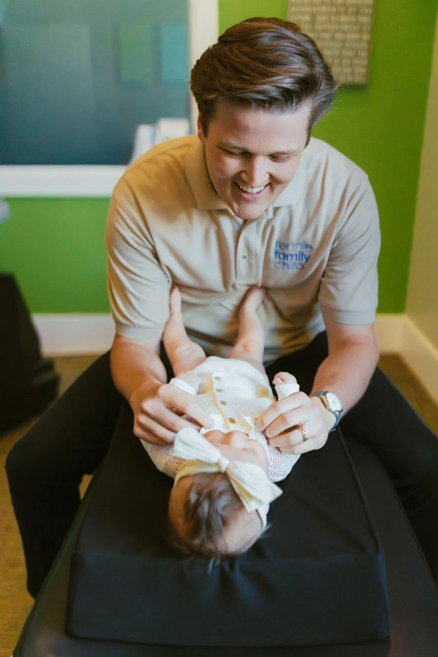 Dr. Cameron Rennie providing gentle infant and family chiropractic care at Rennie Family Chiropractic in Spanish Fork, Utah