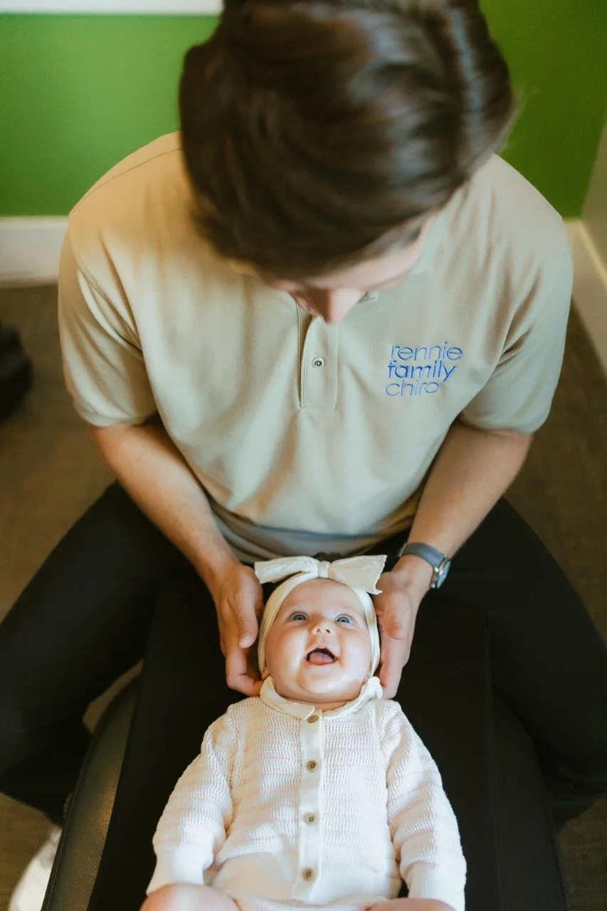Dr. Cameron Rennie providing gentle infant and pediatric chiropractic care at Rennie Family Chiropractic in Spanish Fork, Utah