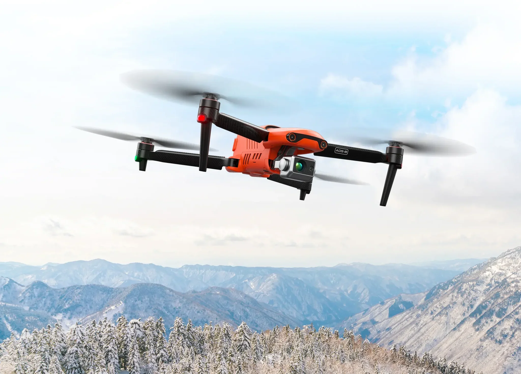 A drone flying over snow-covered mountains and pine trees in a scenic landscape during winter.