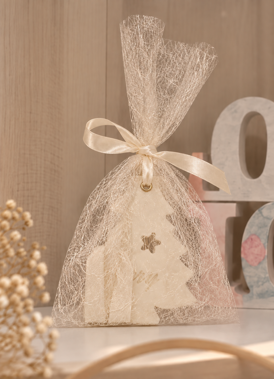 Decorative scented wardrobe diffuser in an organza gift bag with ribbon and floral detail.