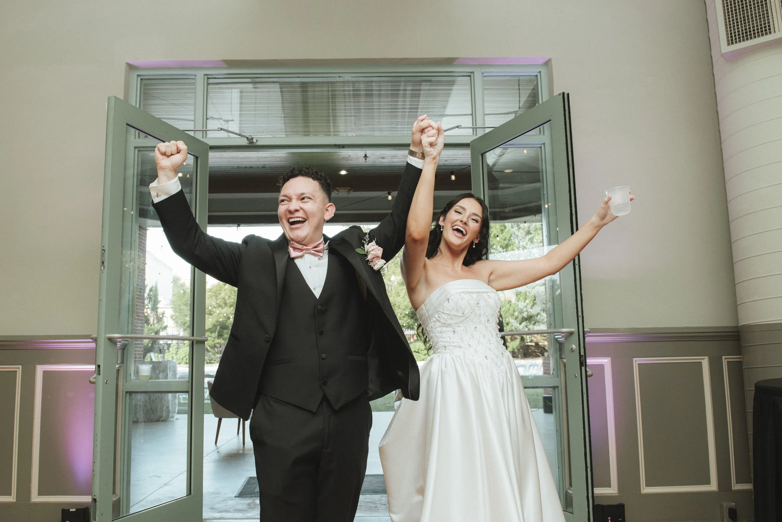 A wedding couple at Indigo Hall in Spartanburg, SC doing their wedding entrance during their wedding reception with their wedding DJ.
