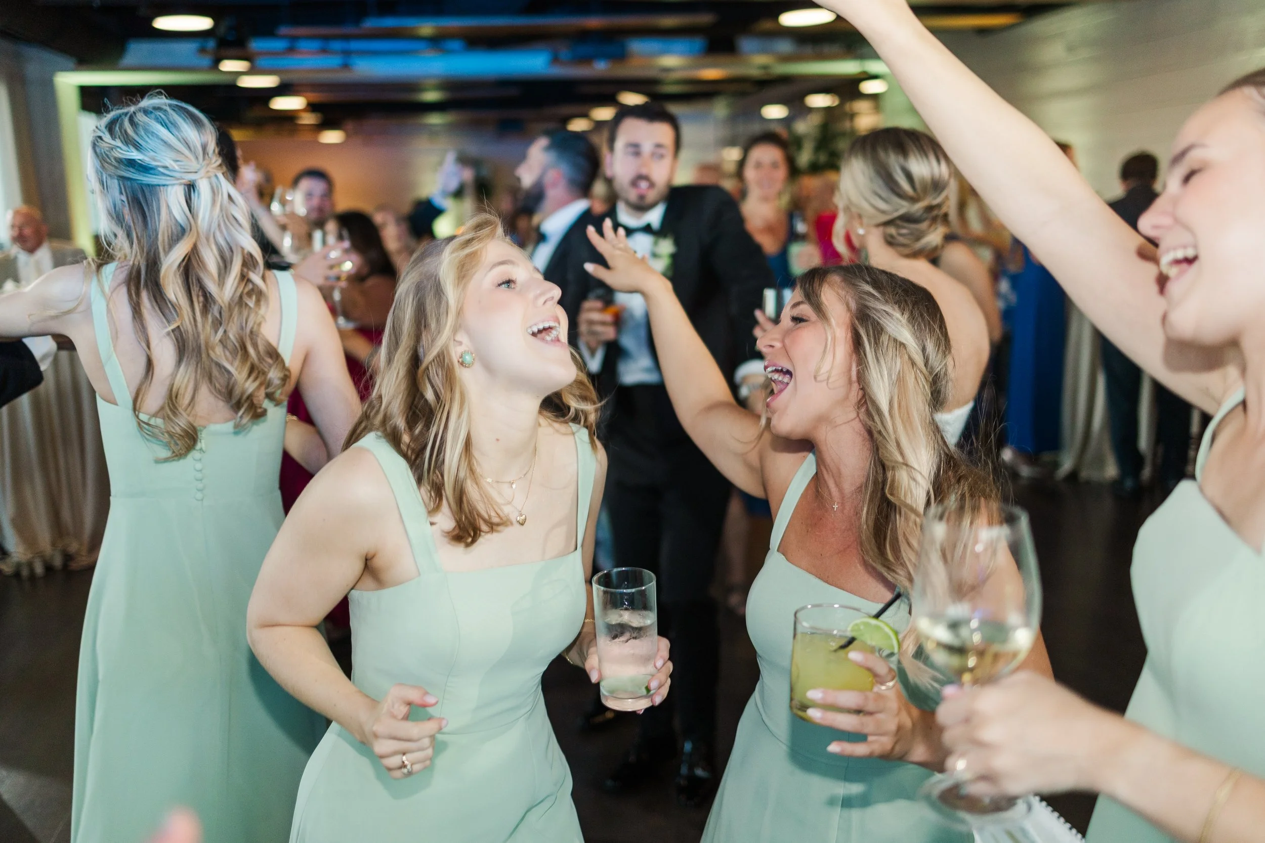 Bridesmaids sing their favorite song as DJ Sam plays music as the wedding DJ at The Avenue in Greenville, SC