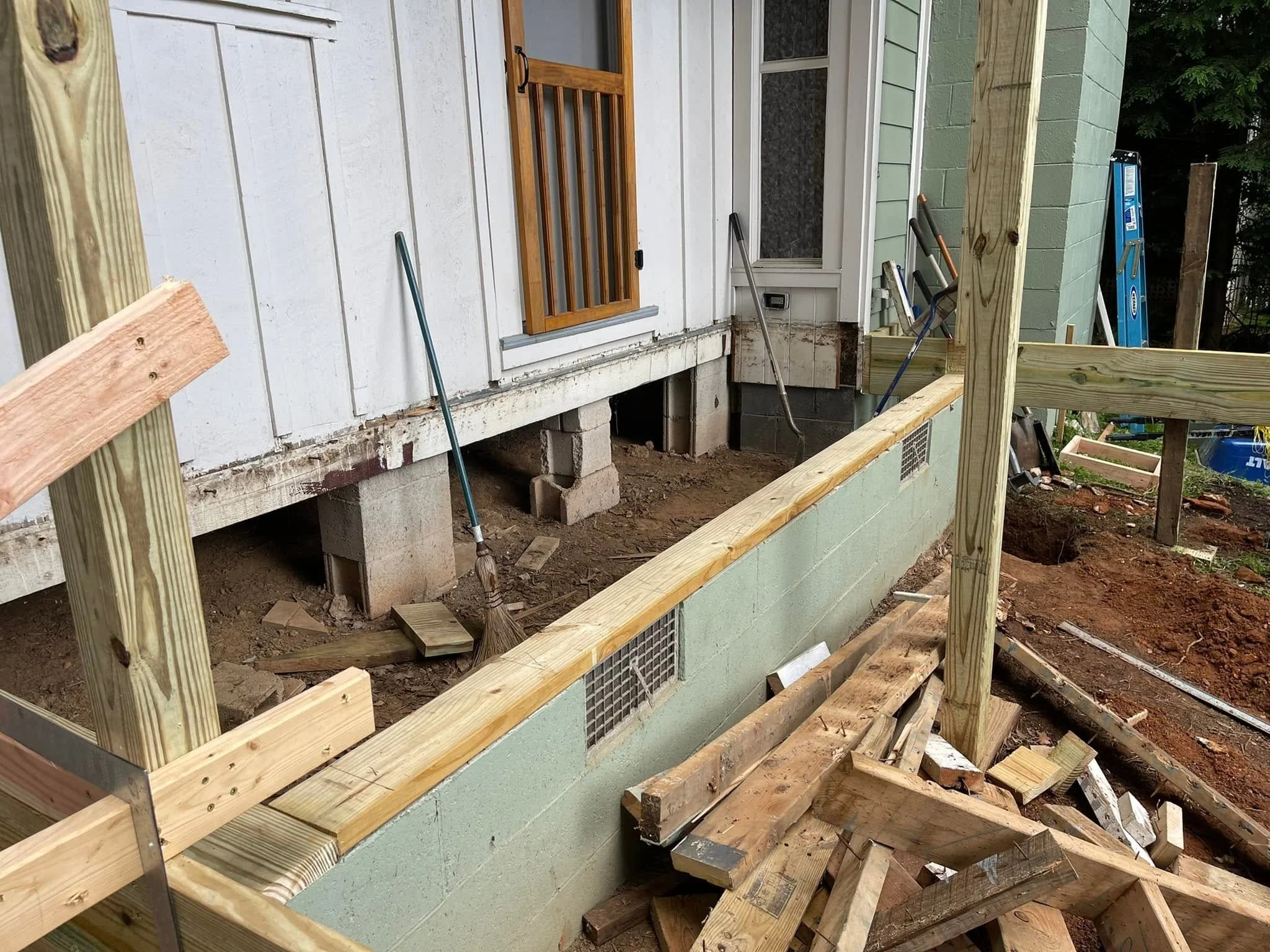 Before: Home addition and deck work in progress, with the foundation and framing visible.
