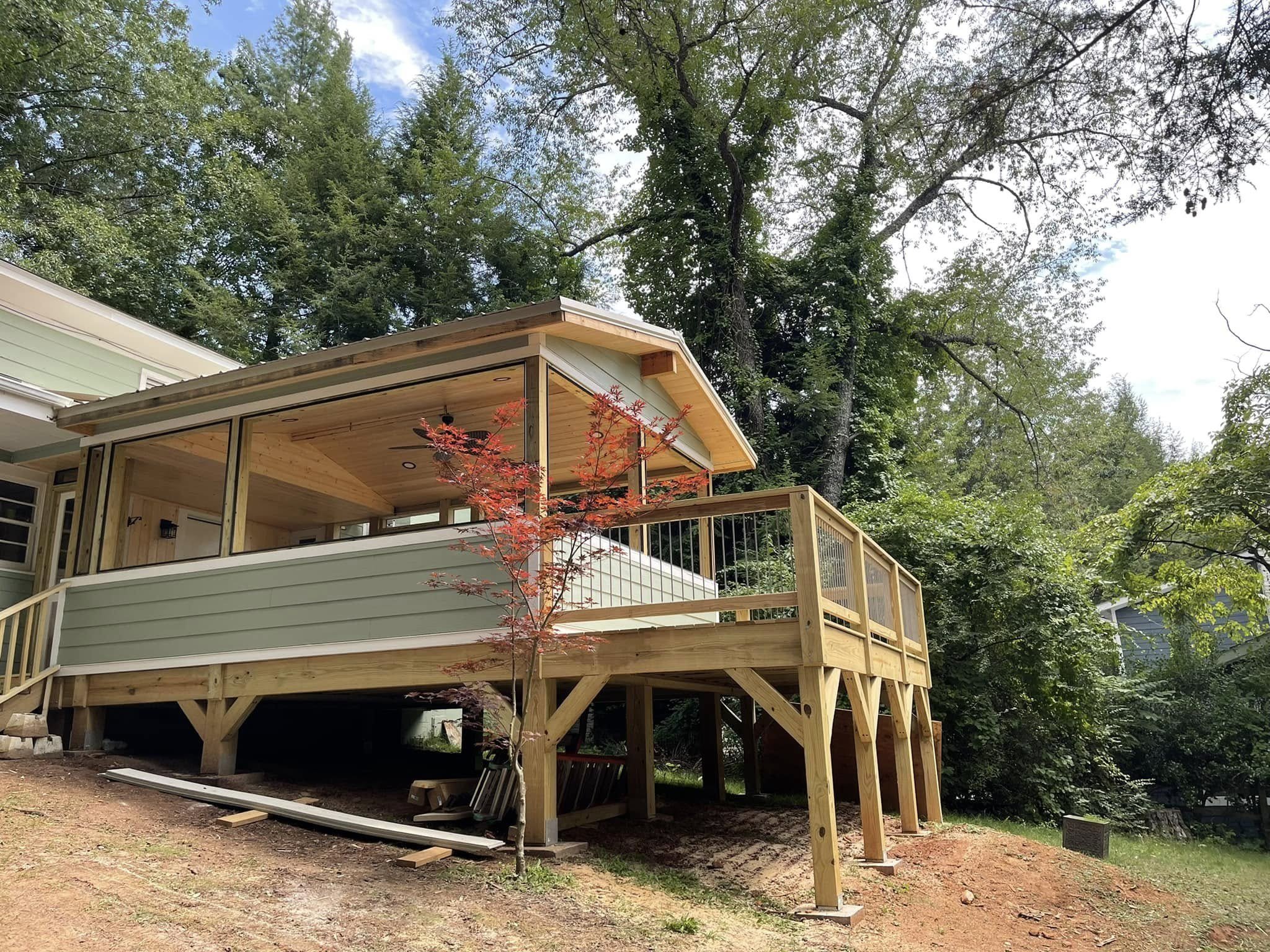 After: Completed home addition with a finished covered deck.