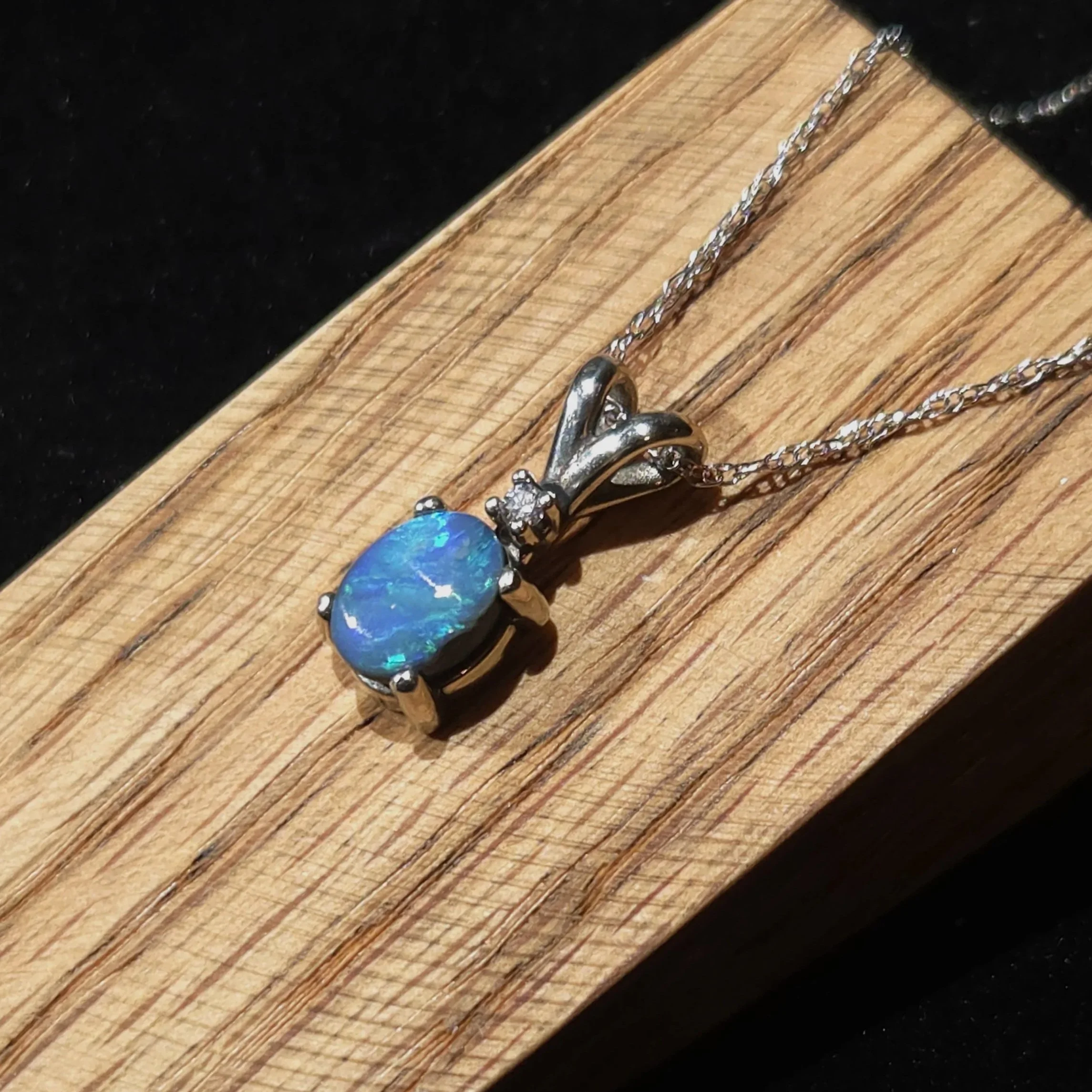 black opal set in 14k white gold with a diamond accent Necklace