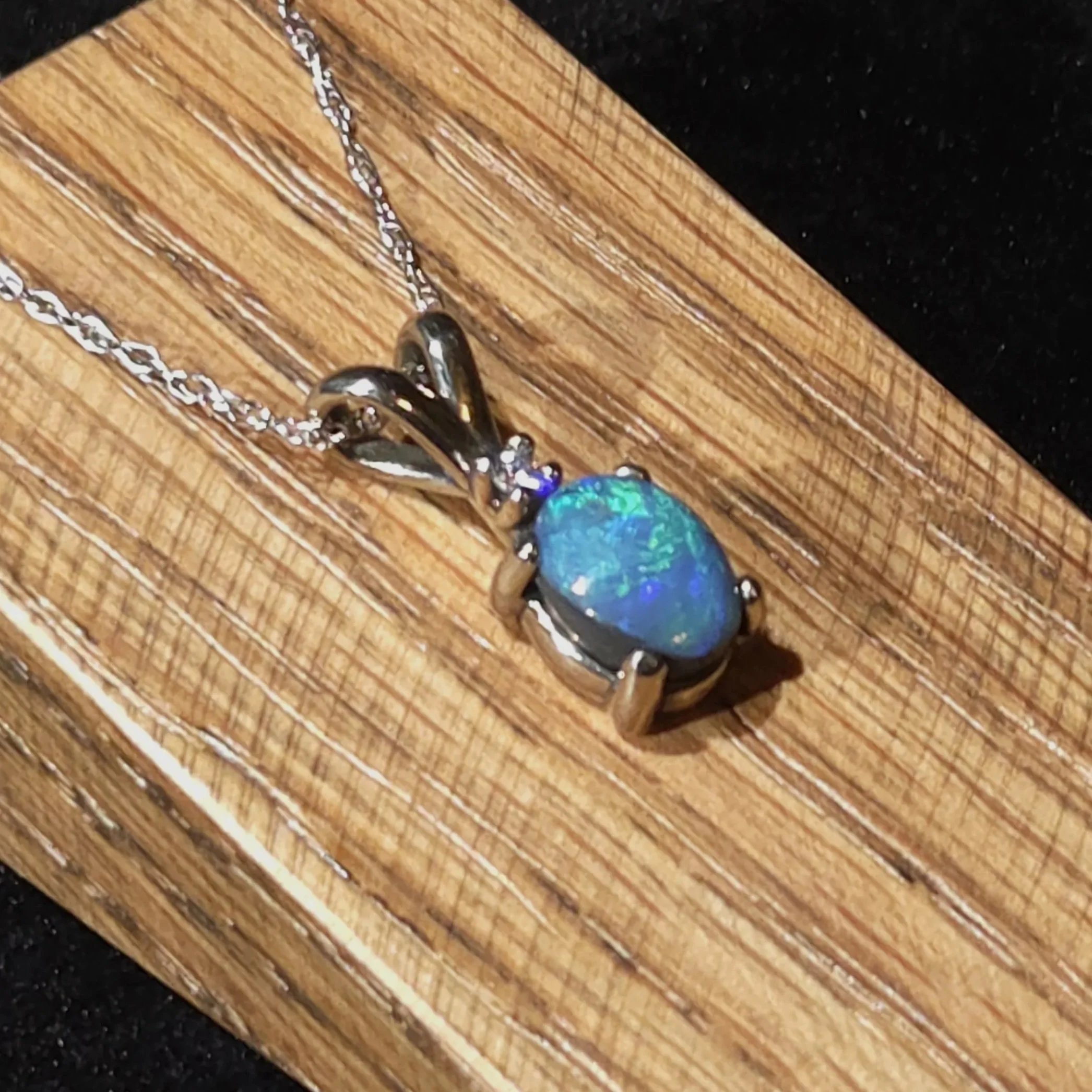 black opal set in 14k white gold with a diamond accent Necklace