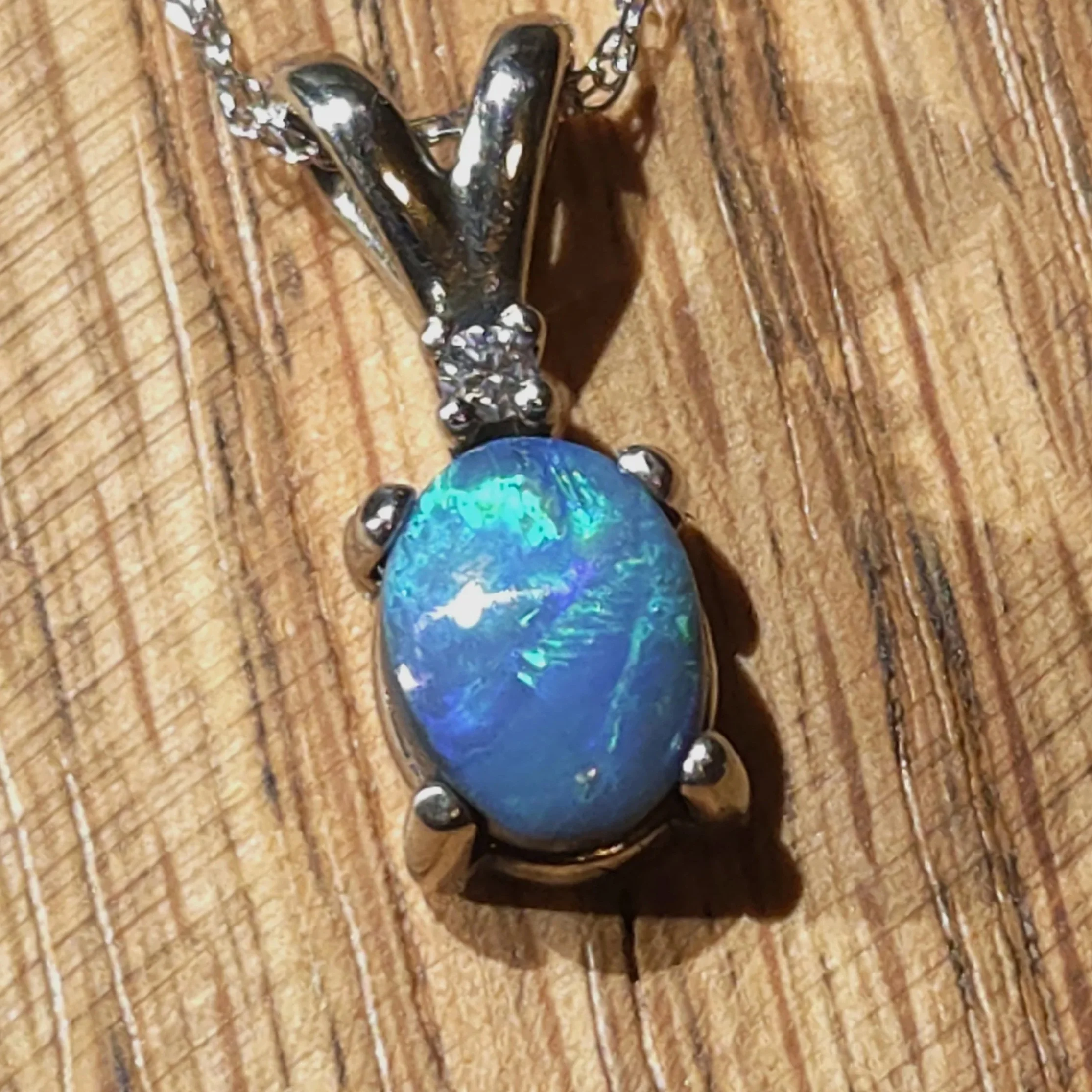 black opal set in 14k white gold with a diamond accent Necklace