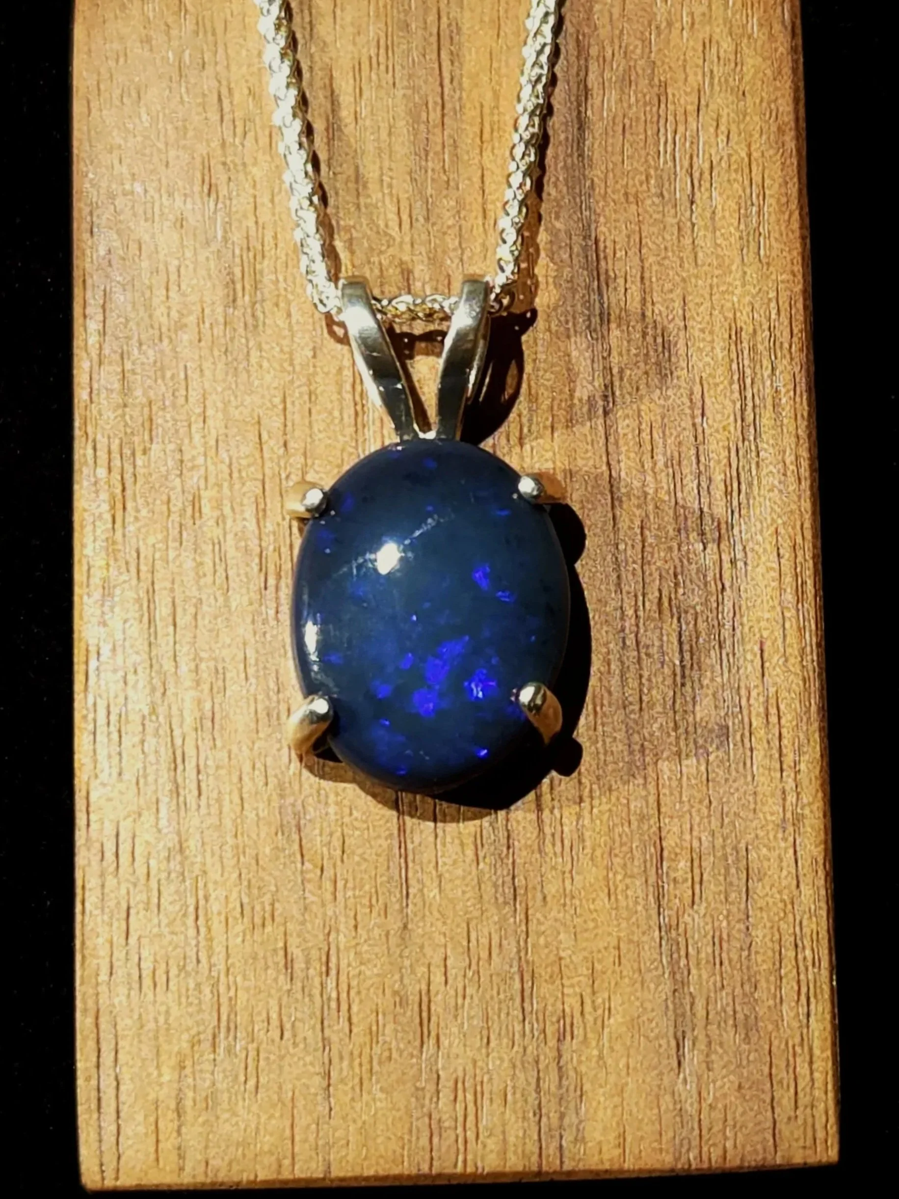 Black Australian opal necklace with flashes like burning blue embers