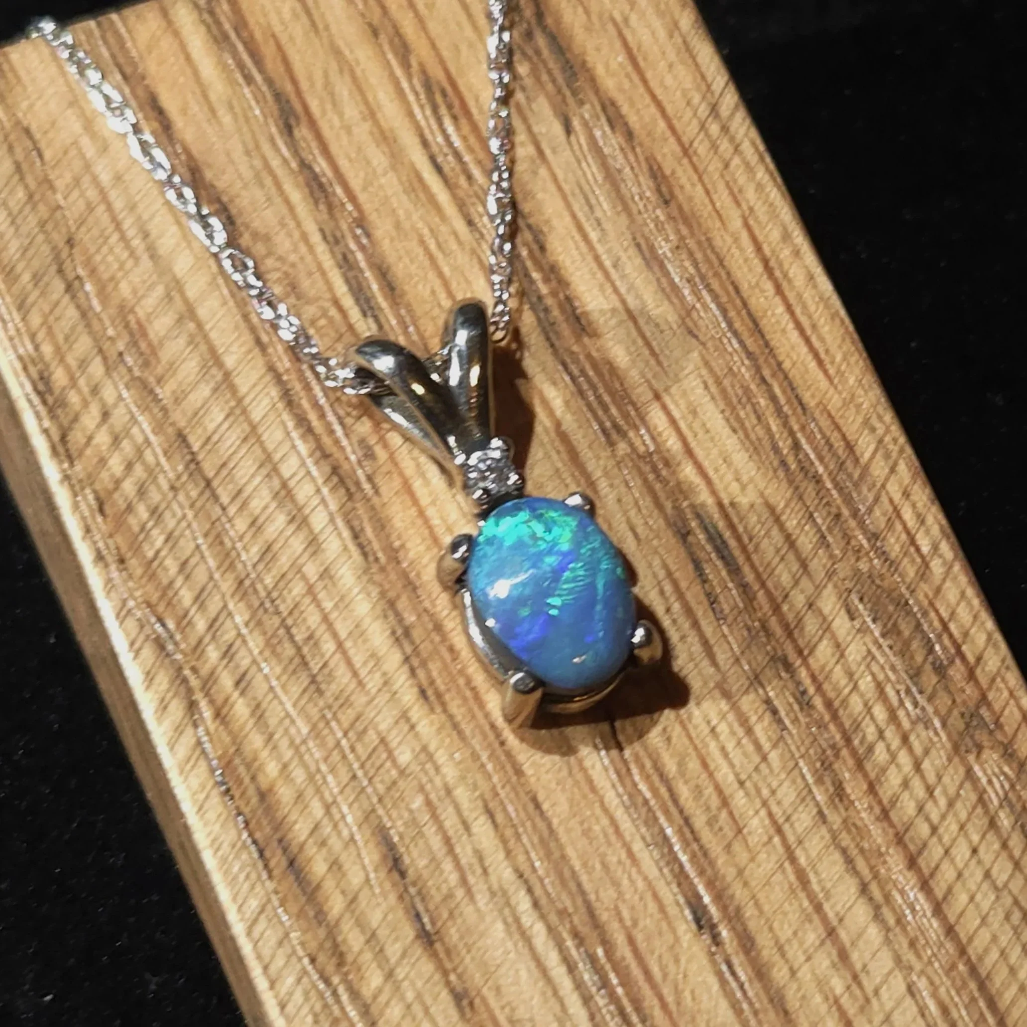 black opal set in 14k white gold with a diamond accent Necklace