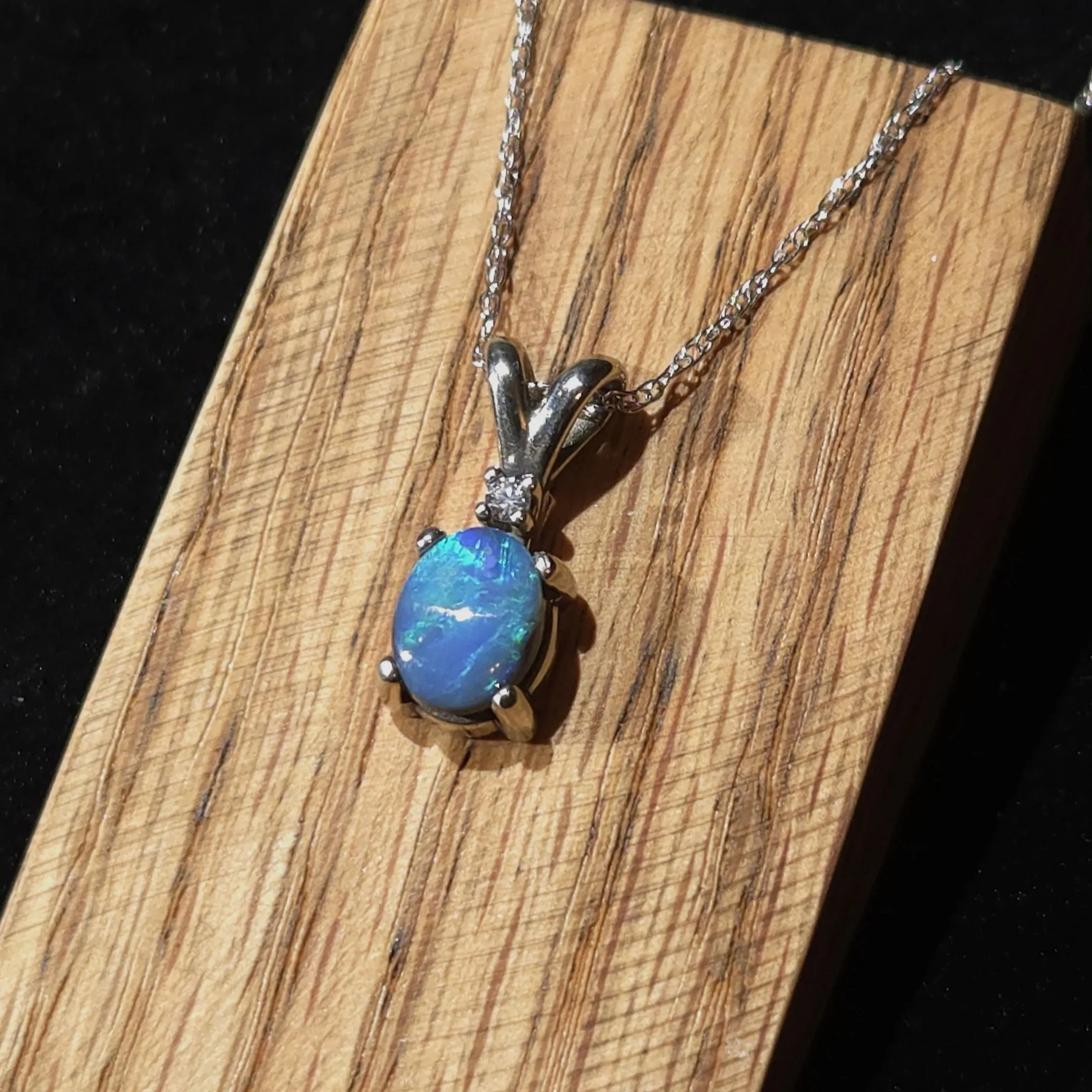 black opal set in 14k white gold with a diamond accent Necklace