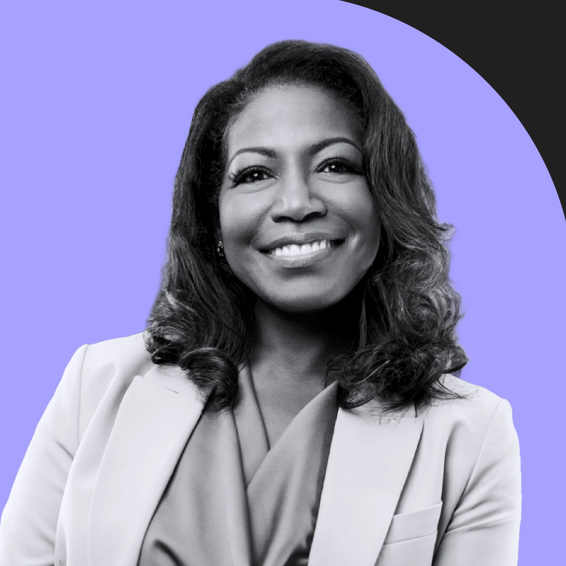 Close-up black and white photo of a smiling woman with long hair and a stylish blazer, against a purple and black background.