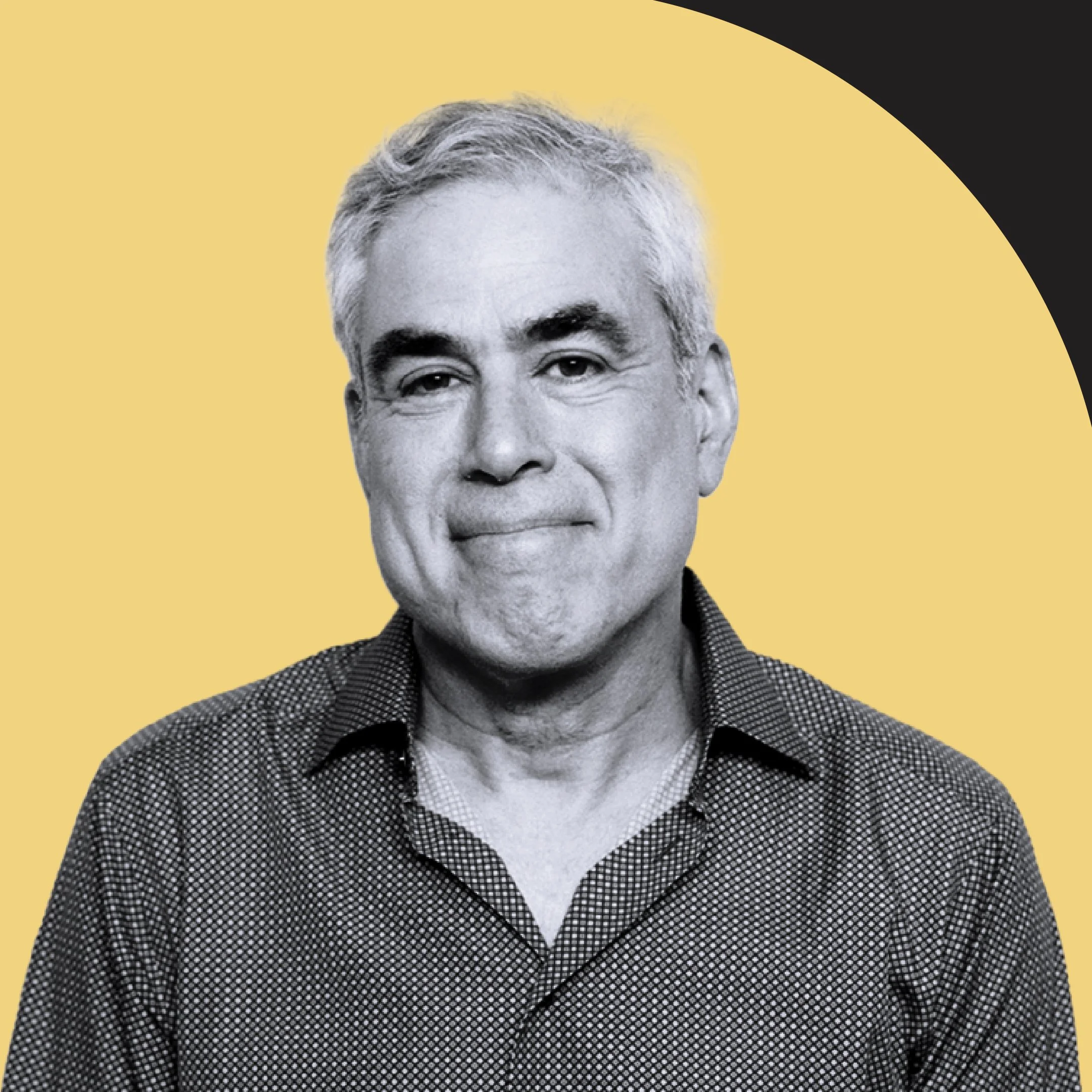Close-up photo of an elderly man with gray hair wearing a black and white checkered shirt against a yellow and black background.