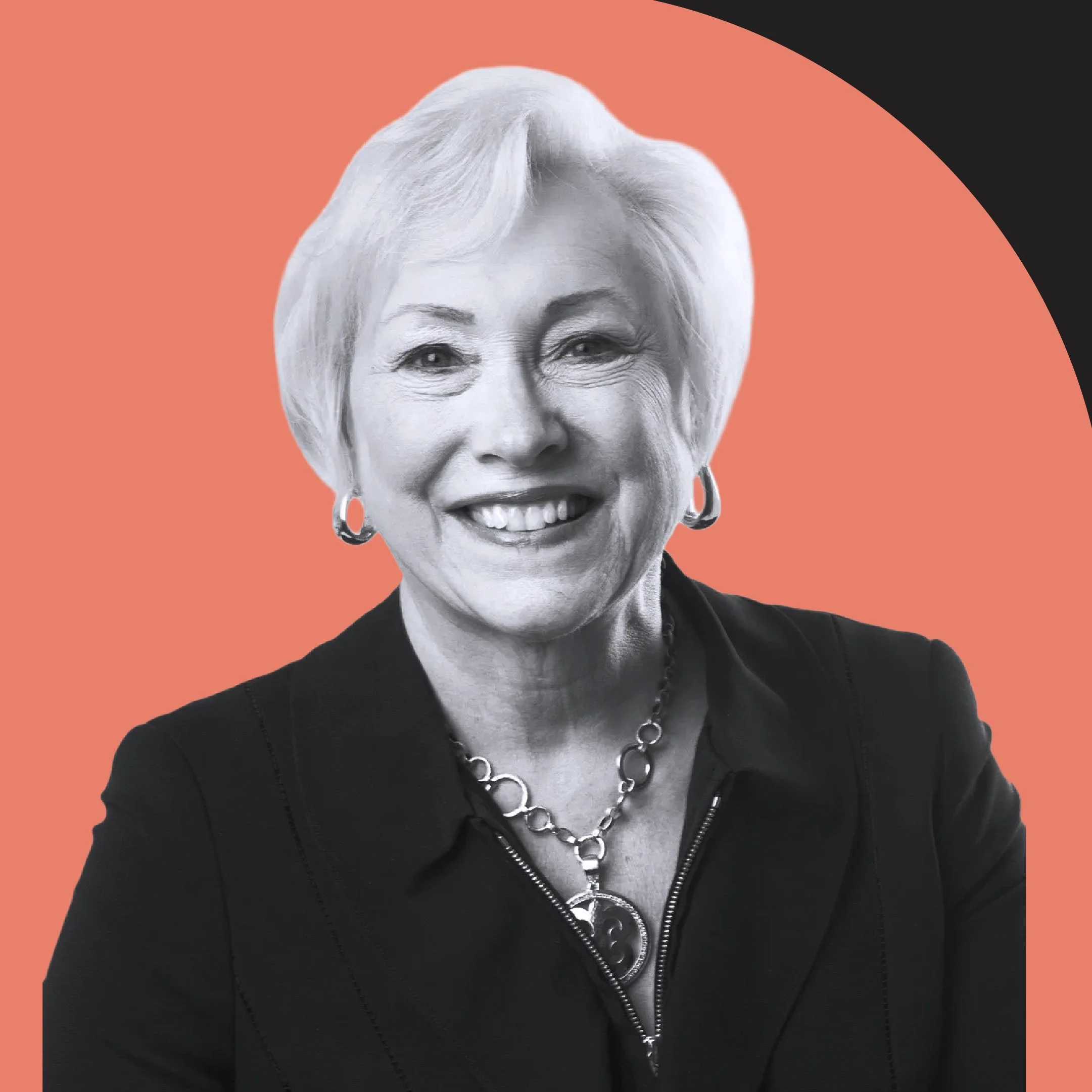 Close-up of an elderly woman smiling, wearing earrings and a necklace, with short blonde hair, against a coral and black background.