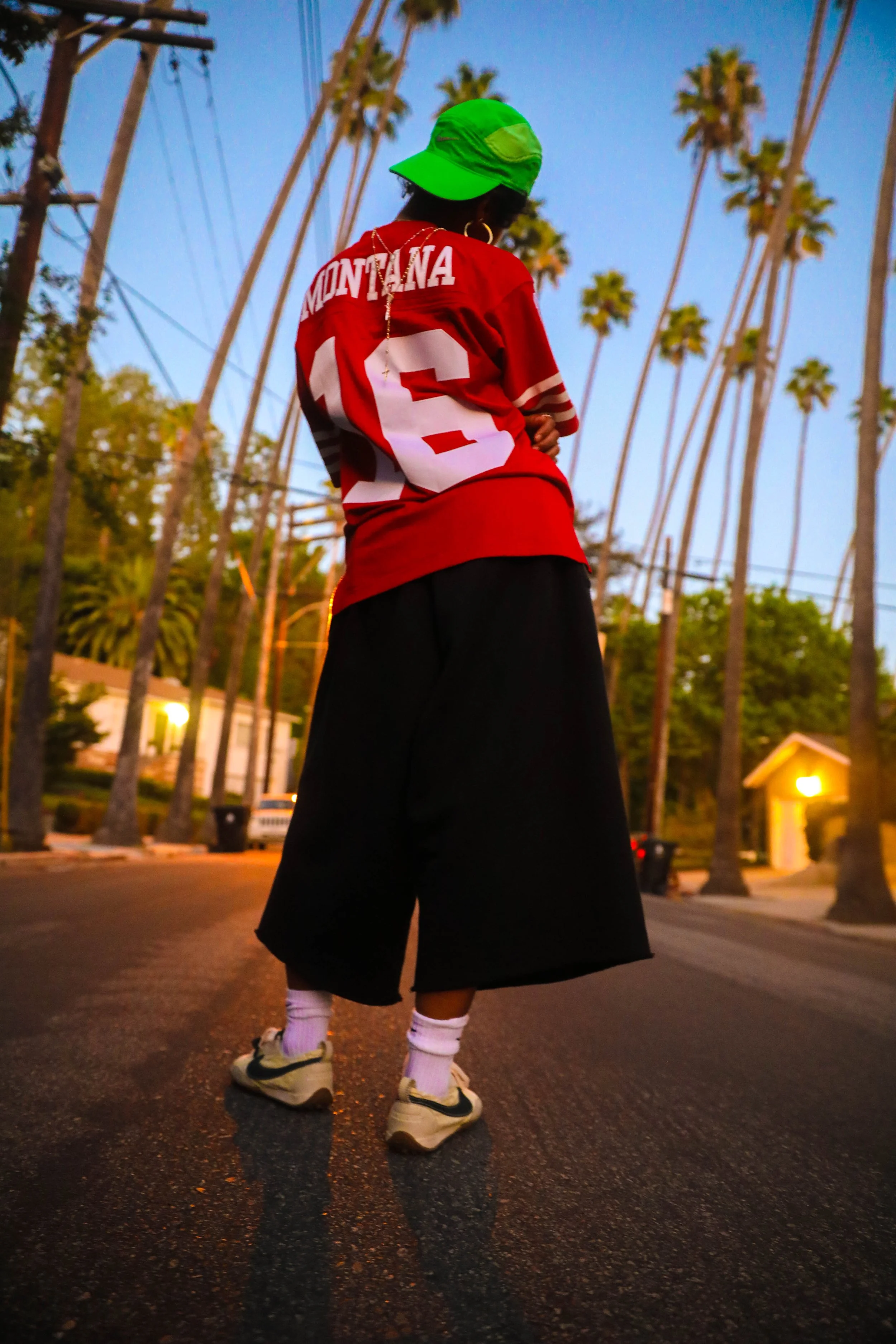 Neysha. Photographer: Sincere Dennis.
Vintage Nike tank top and raw denim: Mom n Dad LLC.
49ers jersey: Press esc. @press_______esc
Hat: Nike & New Era.
Shorts: Ghetto Rodeo.
Sneakers: Jacquemus x Nike.
