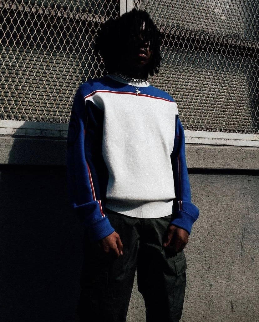 Kenny Mason.

Photographer: Ellington Hammond.
Producer: Ashley Outrageous.
Management: Aditya Pamidi.
Denim jacket and jeans: Diesel.
Blue sweater: Diesel.
Hoodie: Advisry.
Vintage Calvin Klein maroon denim: Press_____esc.
Vintage baseball shirt: Pr
