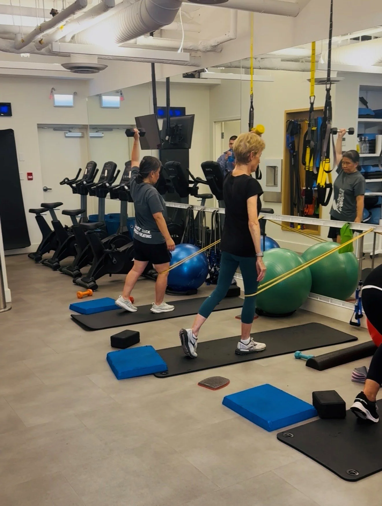Small group osteoporosis strength class using weights and resistance with a kinesiologist coaching