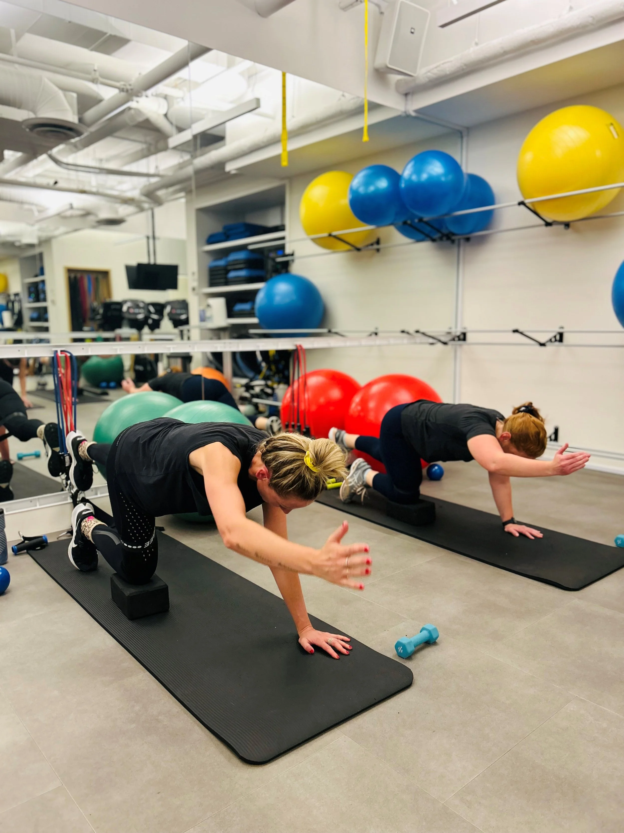 Client doing a core stability exercise on a mat during lower back rehab in North Vancouver