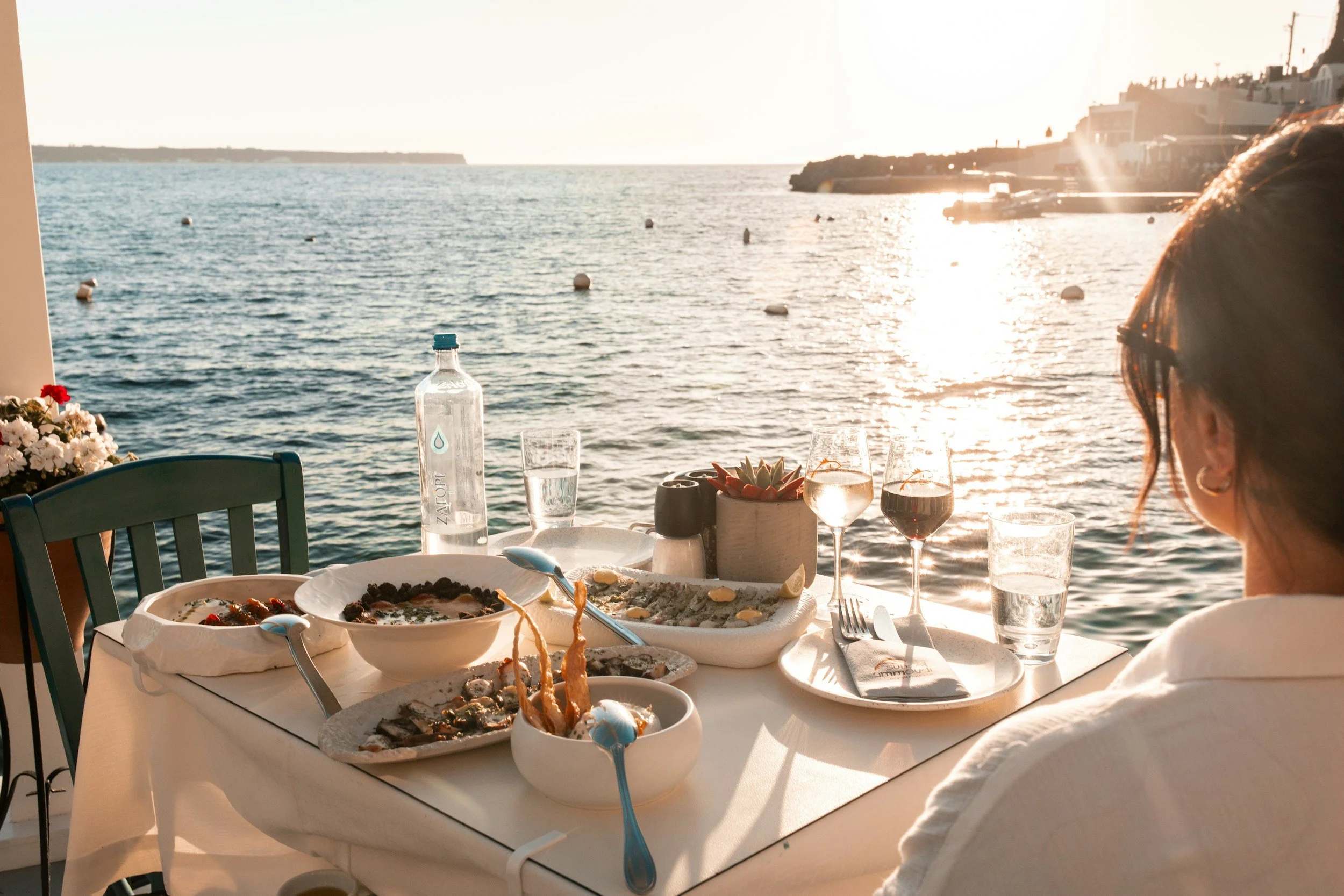 Business traveler enjoying a seaside meal, travel concierge for founders