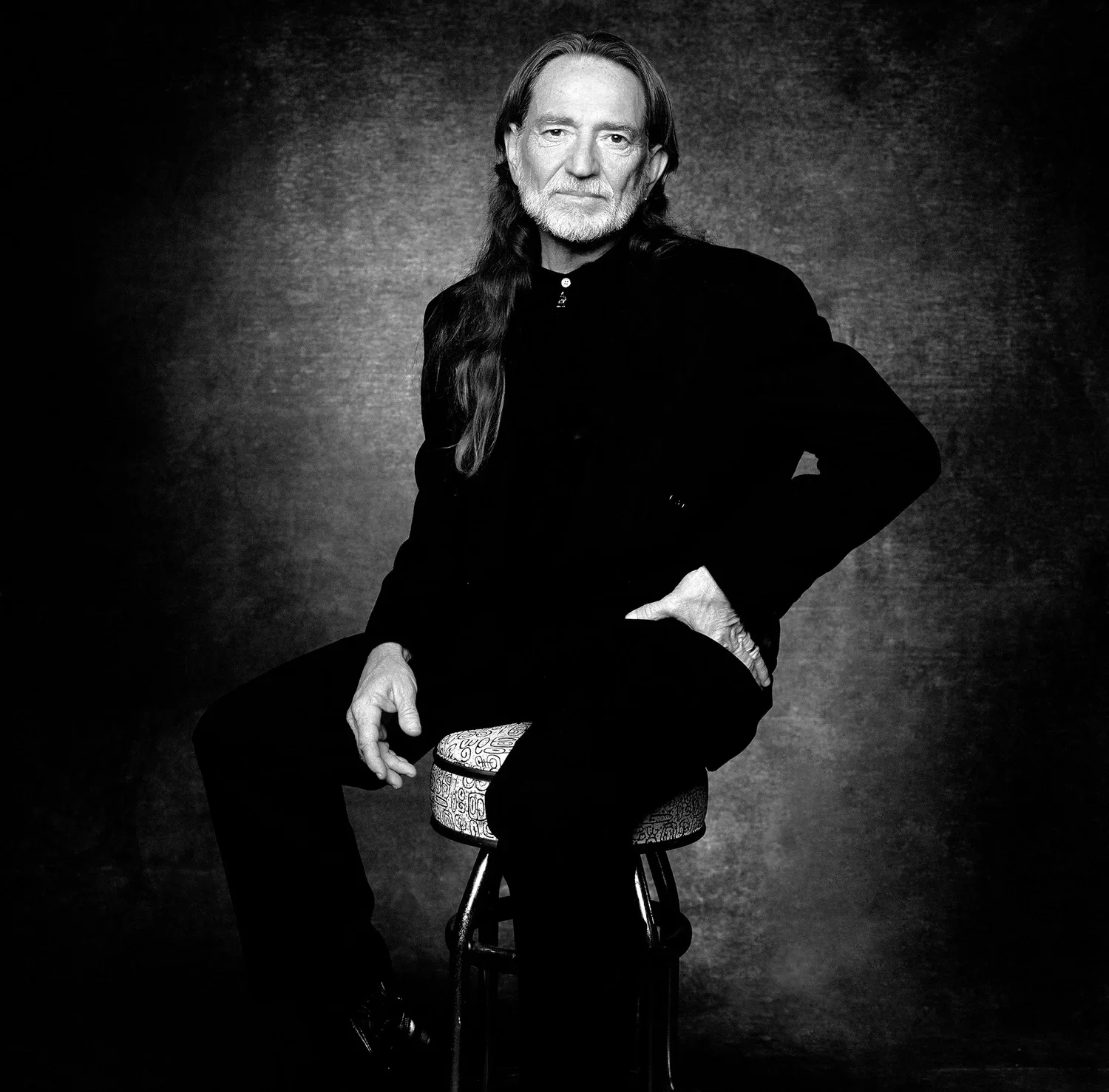 Music legend Willie Nelson black and white seated studio portrait photographed by Ken Sax.