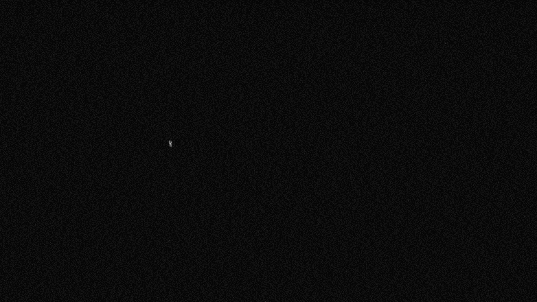 A mostly black image with a small white pinpoint of light in the upper left portion.