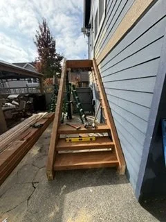 New wood steps take shape below the upper landing as the stair reconstruction moves forward. This stage shows the treads and side supports in place before the railings and finishing details are completed.