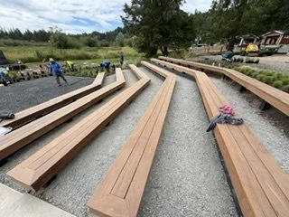 The seating installation follows the angled layout of the supporting frames. Fitted boards create continuous bench surfaces while preserving the walkways between rows.