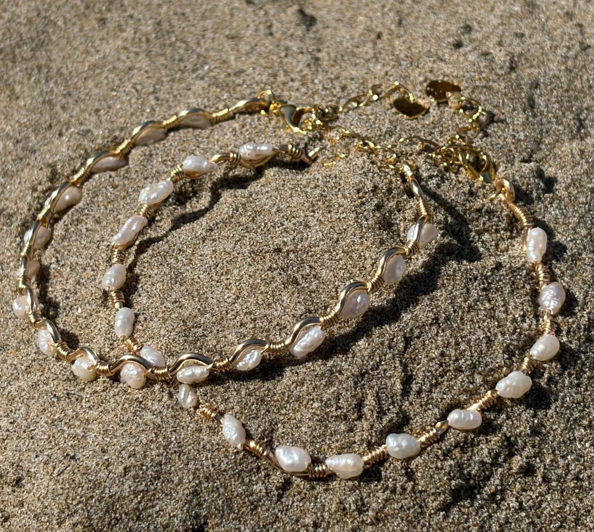 Freshwater Pearl bracelet wrapped around a gold squiggle wire band.