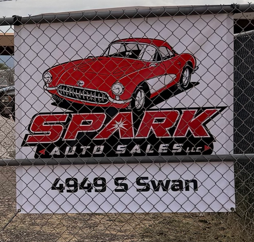 Sign for Stark Auto Sales featuring a red vintage car illustration, located at 4949 S Swan.