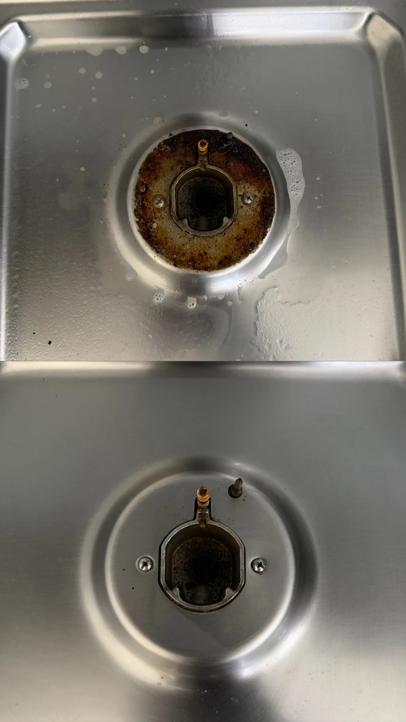 Close-up of a kitchen sink drain with rust and grime buildup around the edges.