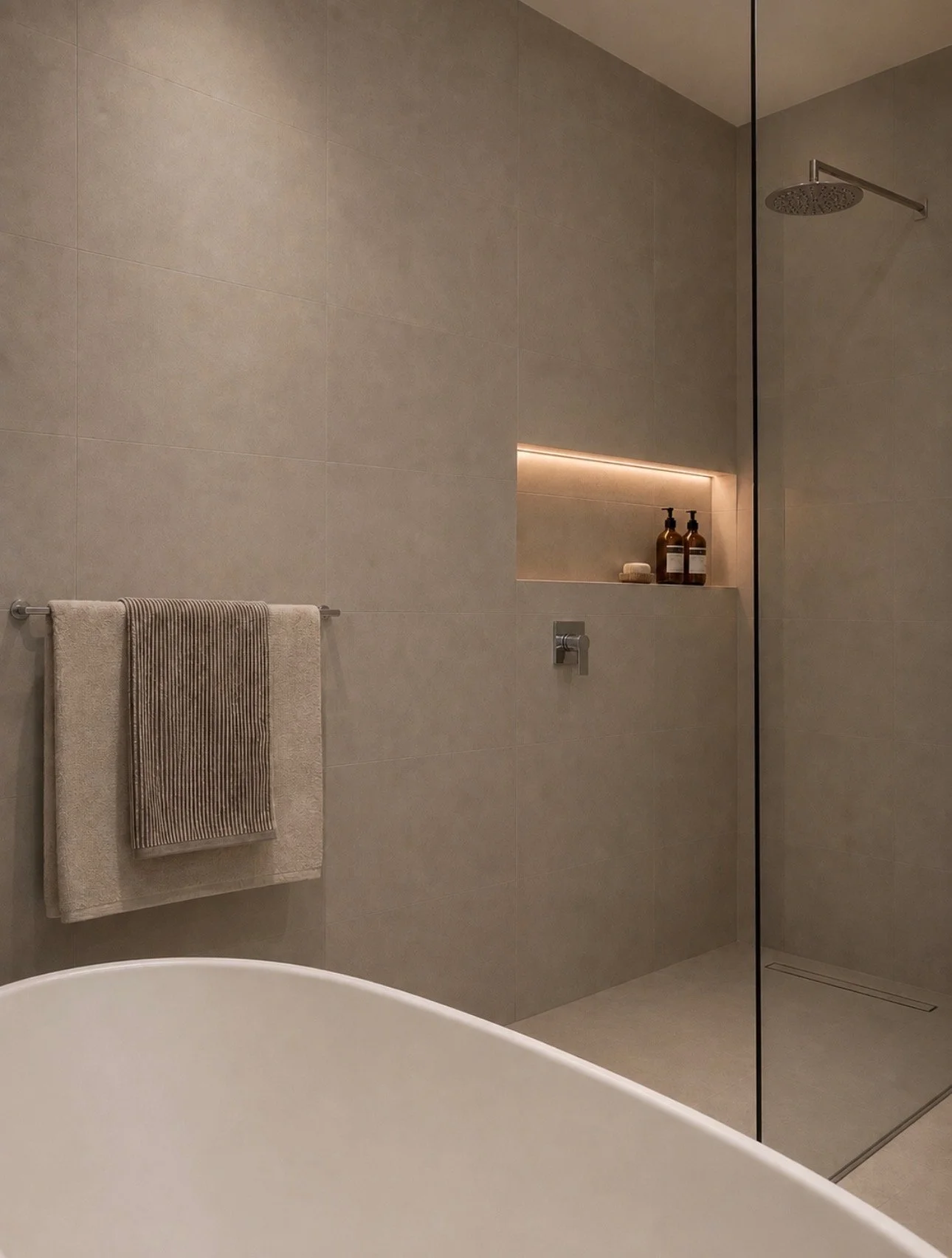Finished Blackburn bathroom with tiled shower and wall mounted fixtures.