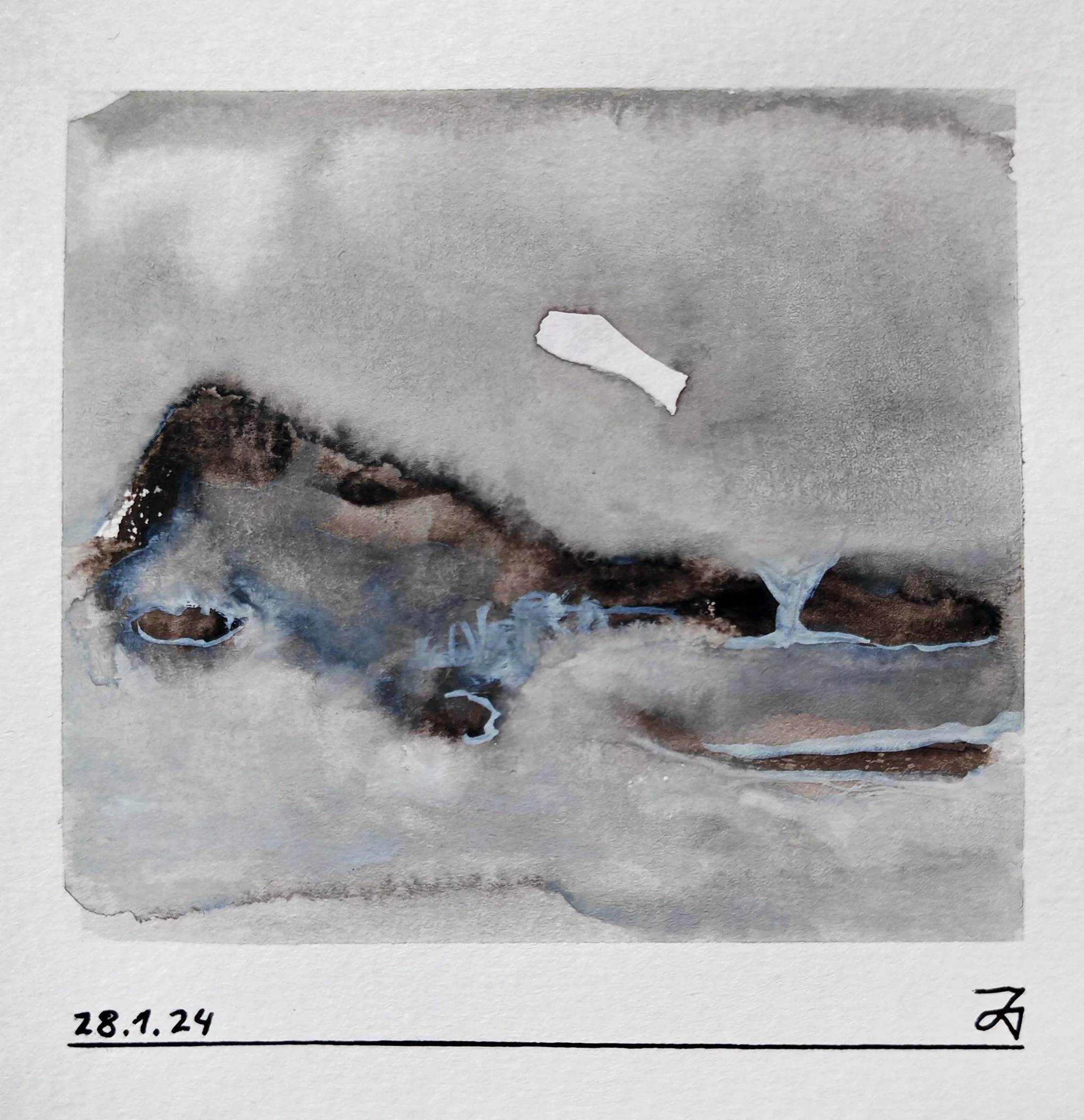 A grayscale photograph of a mountainous landscape with a body of water in the foreground. Part of a torn paper with a jagged edge is visible at the bottom, next to some handwritten text including a date, '28.1.24', and initials 'Z'.