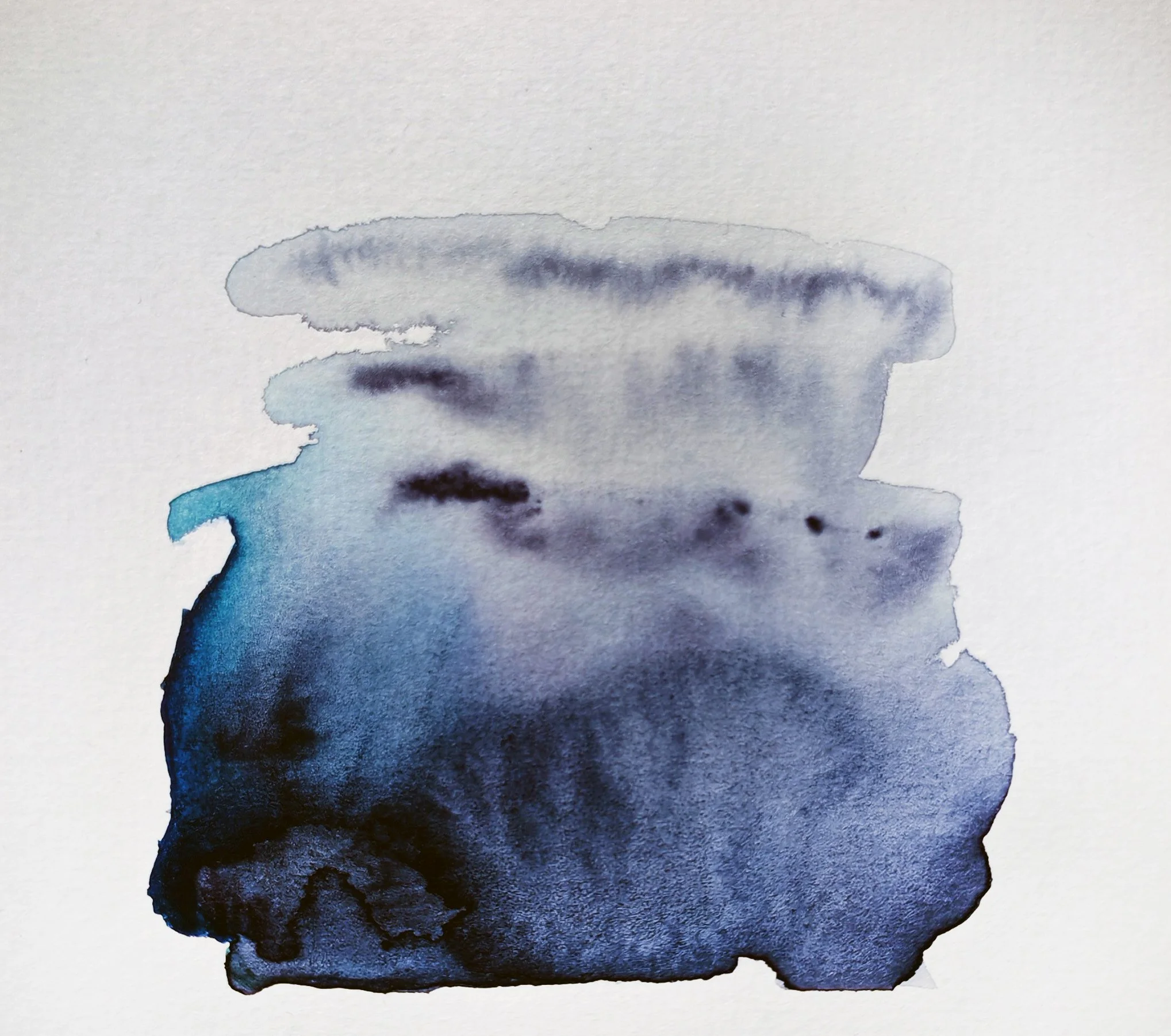 Abstract watercolor painting with shades of blue, black, and gray on textured paper.