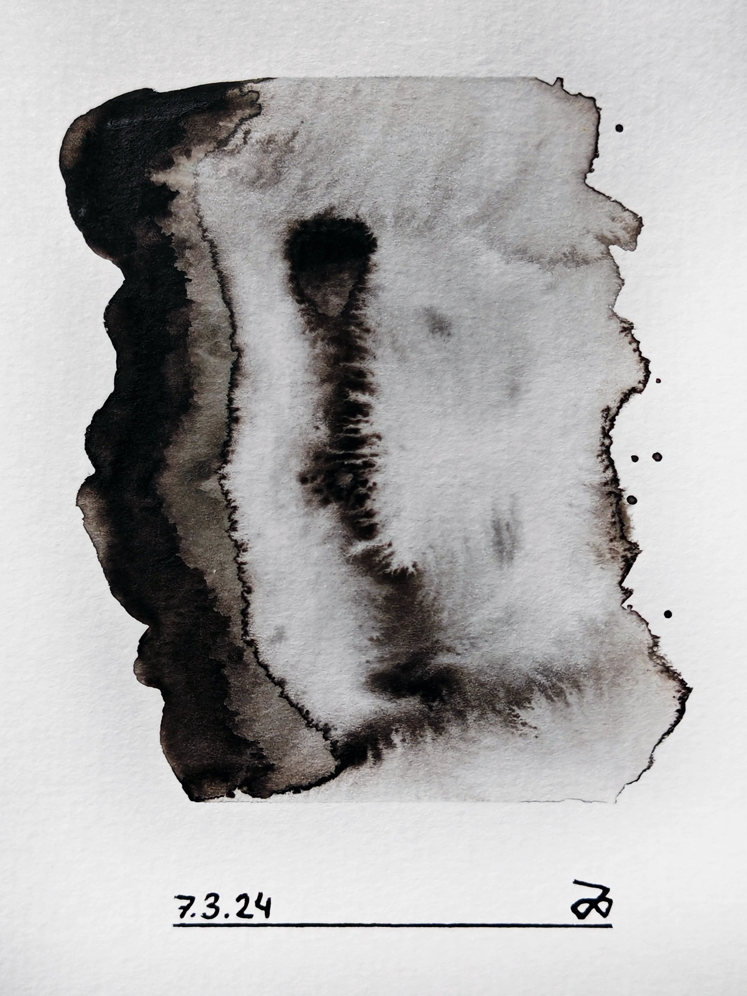 A black ink art piece resembling a bull head on white paper, with the date 7.3.24 written below in black ink.