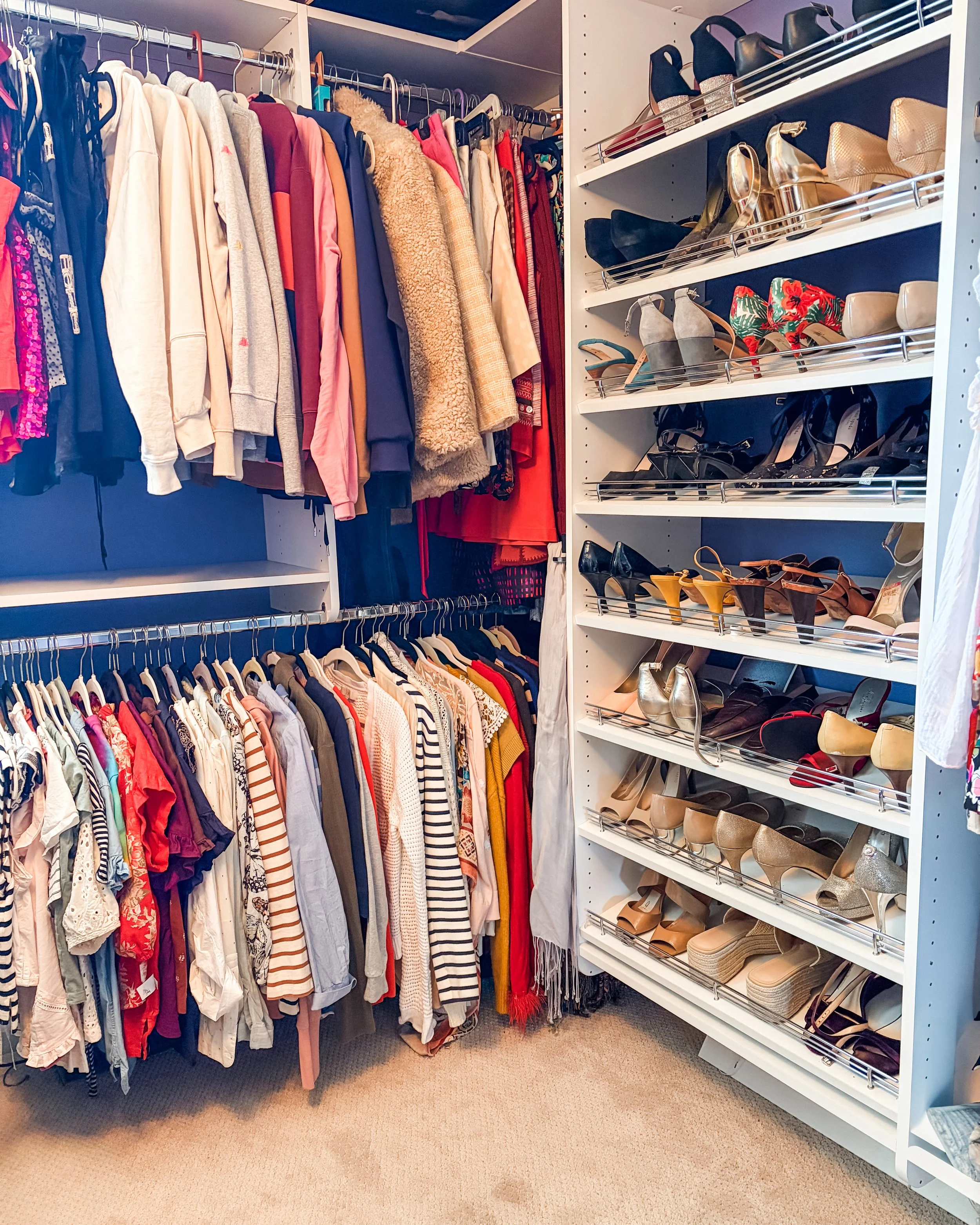 A closet with hanging clothes on the left side, including dresses, blouses, and hoodies, arranged by color and style. On the right side, there are shelves with women's shoes, including heels, sandals, and flats, organized by type and color.