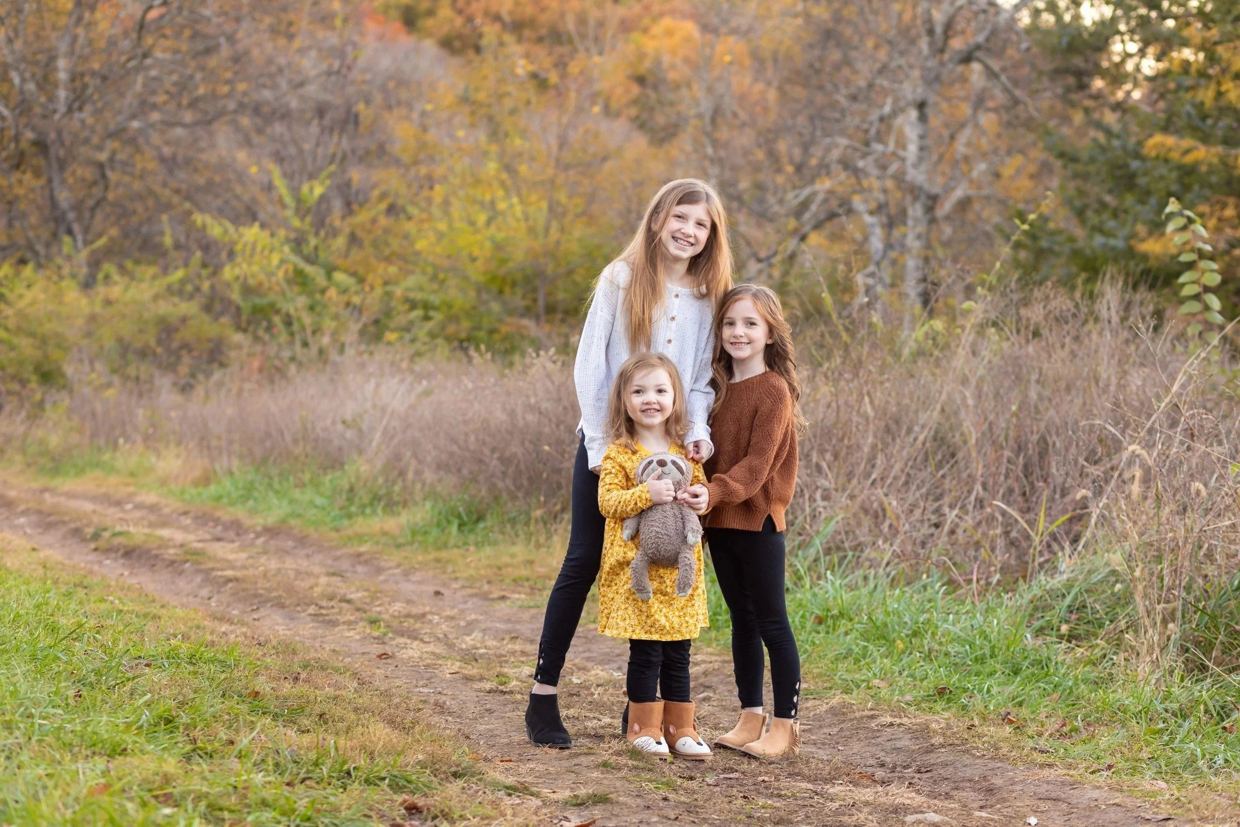 Three sisters on a grassy path at Smith Park in Brentwood, TN