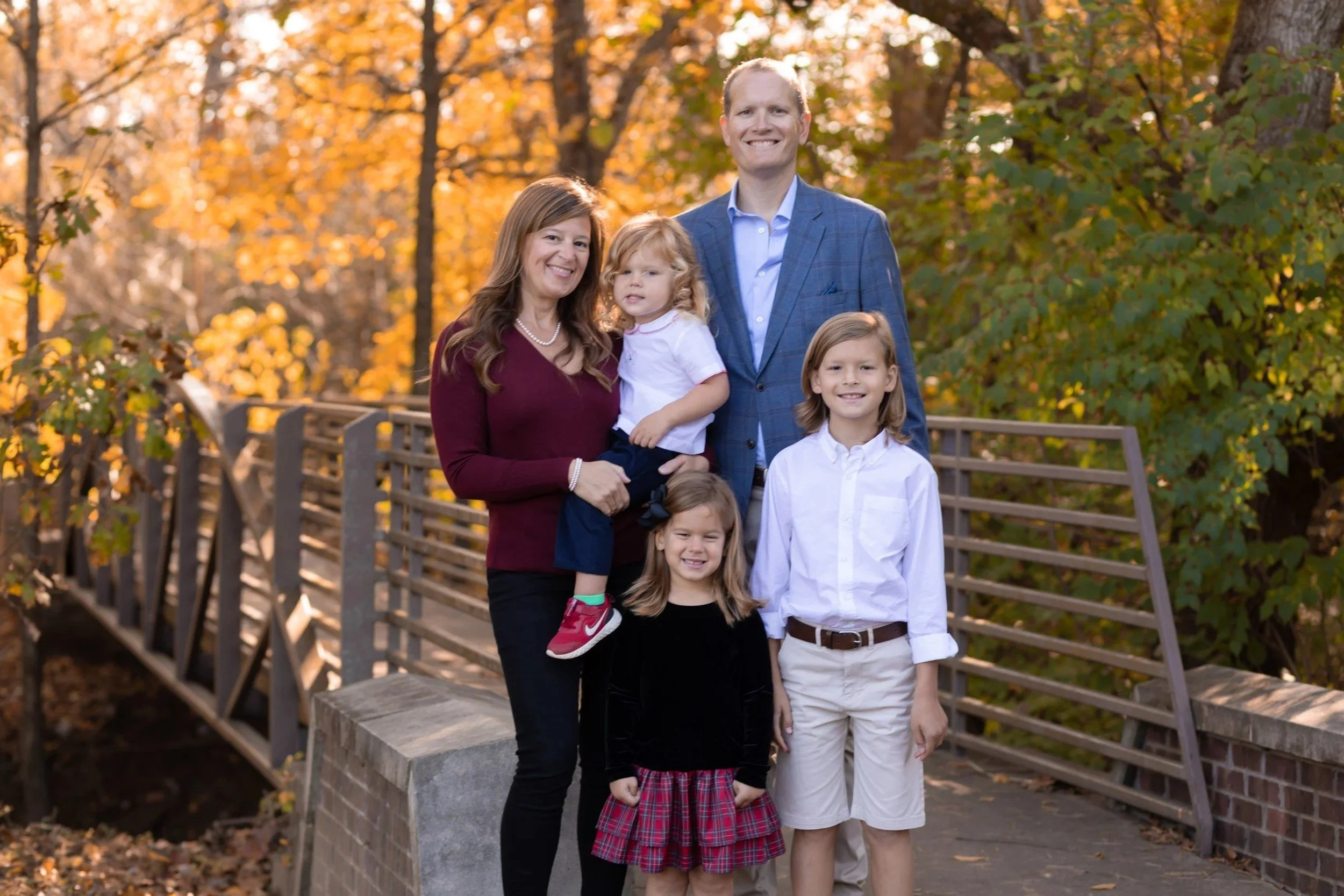 Family of five on the wooden bridge at Aspen Grove Park in Franklin, TN