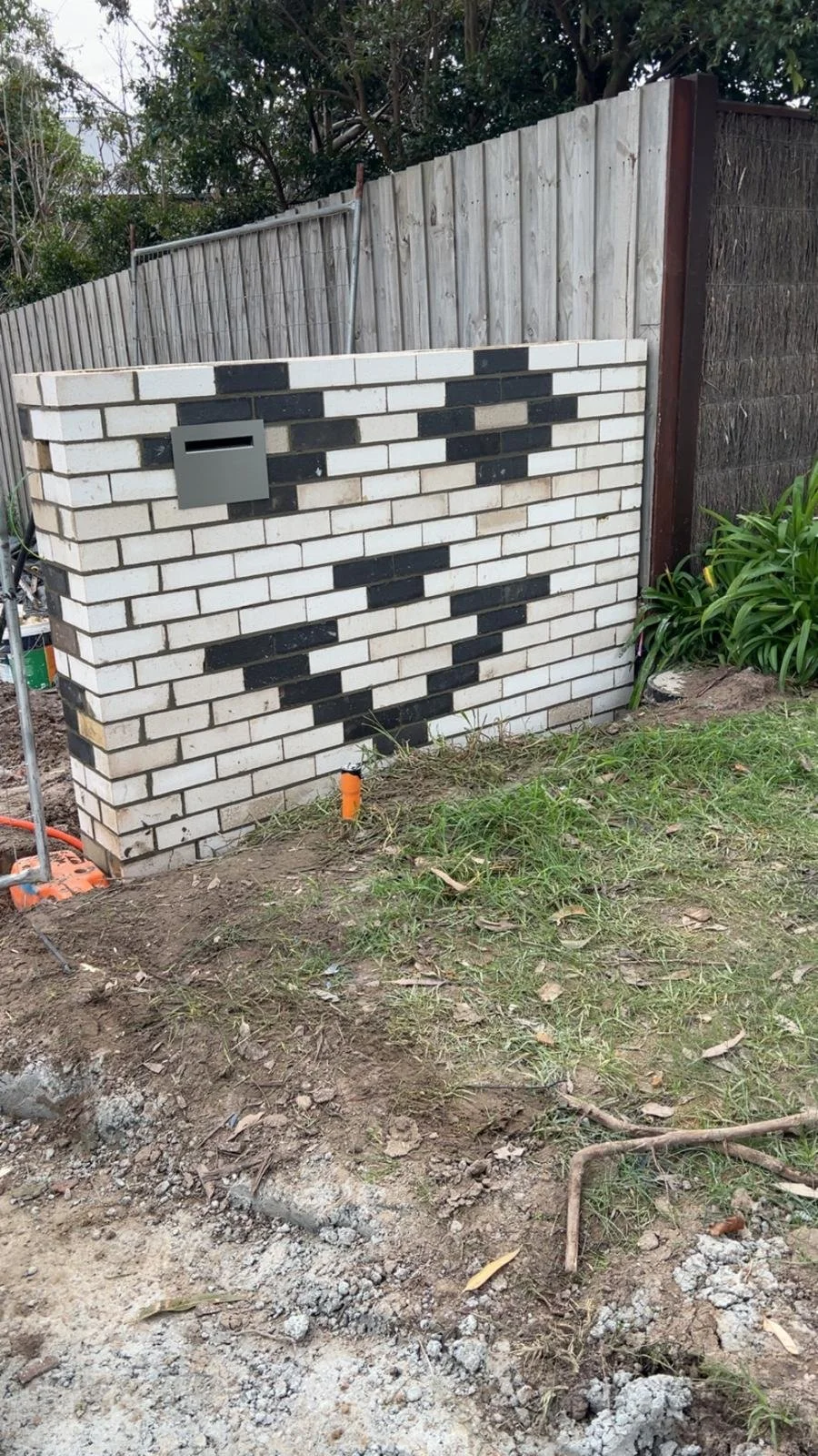 White brick exterior with dark accent bricks for a striking finish.