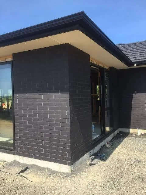 Dark face brickwork gives this modern home a bold, clean exterior.