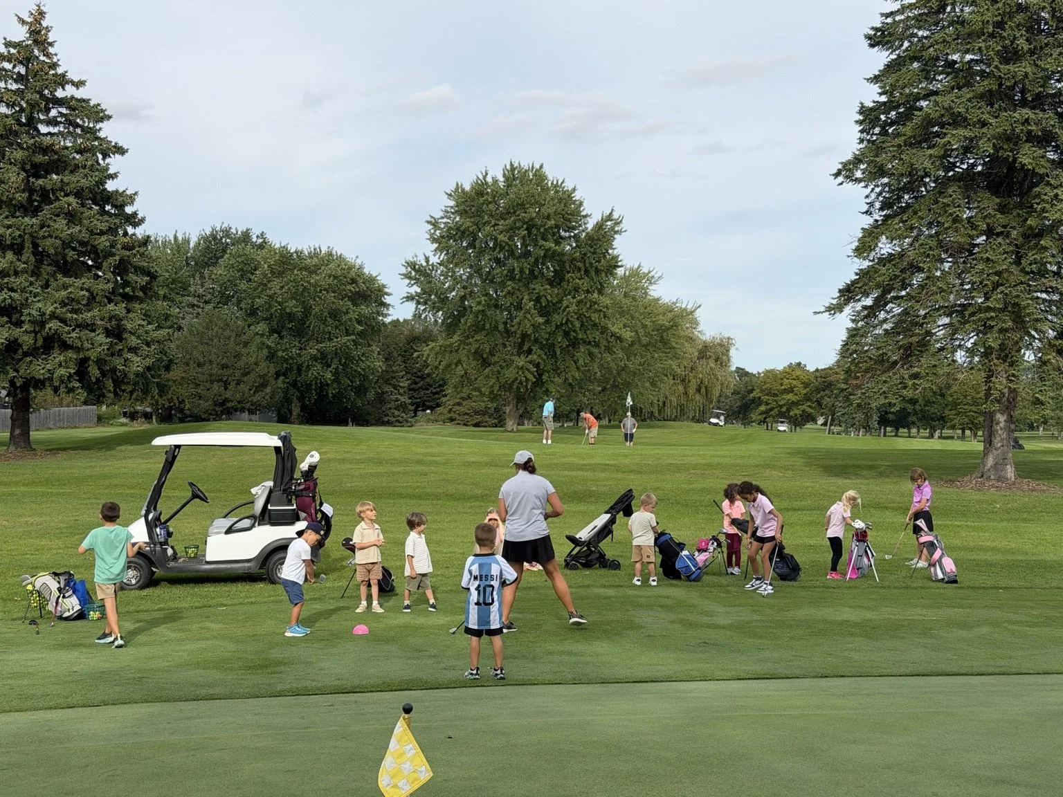 Young golfers practice together during an Elevate Little Birdies session on the golf course.