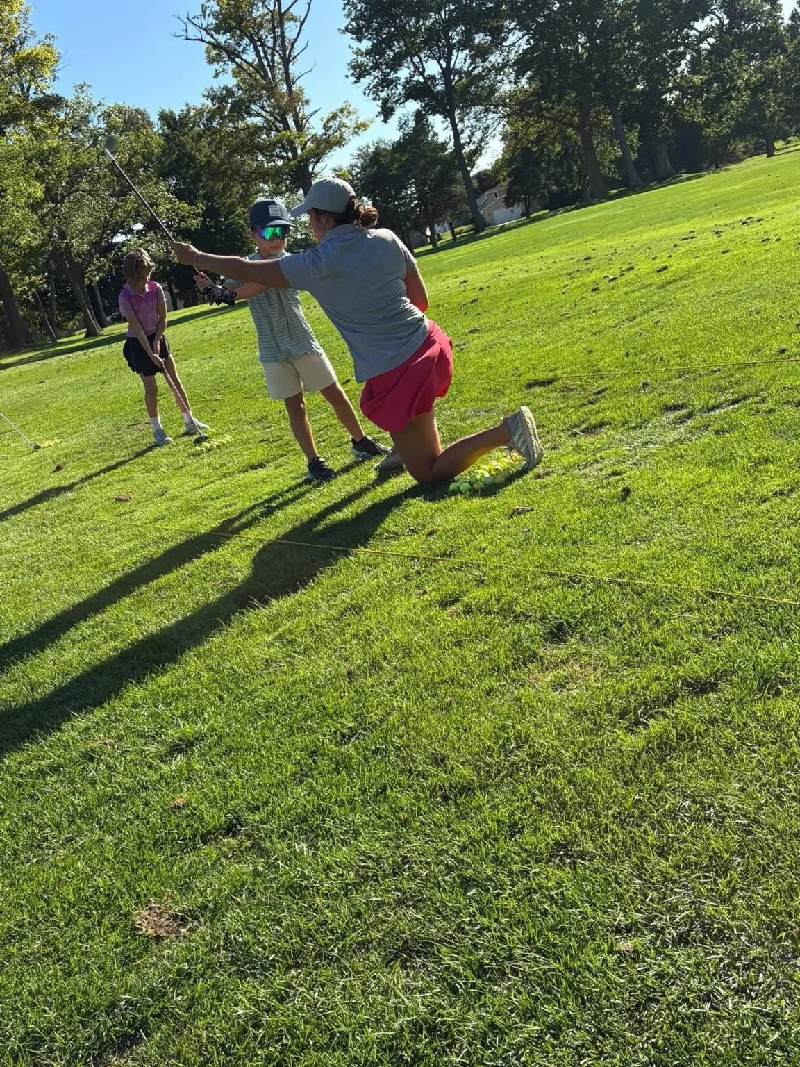 Kelsey coaches junior golfers during an Elevate 36 practice.