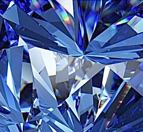 Close-up of a large, faceted blue diamond with multiple sharp angles and reflective surfaces.
